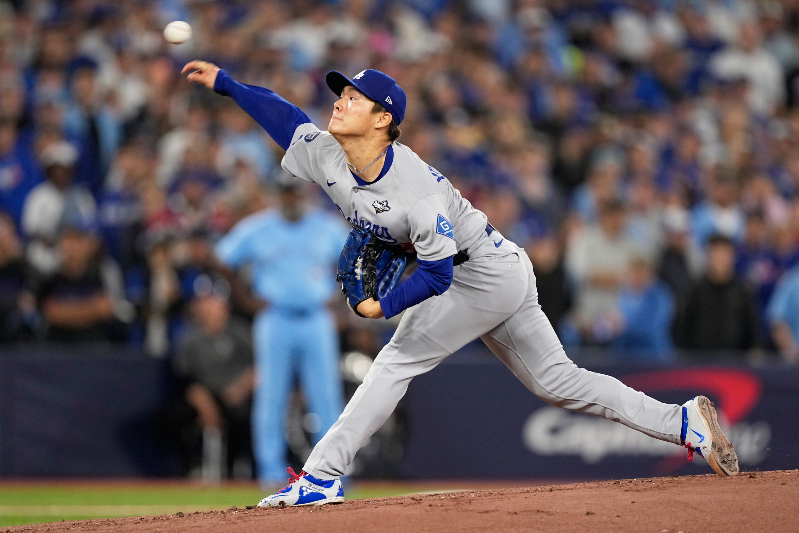 Dodgers starting pitcher Yoshinobu Yamamoto throws to the plate against...