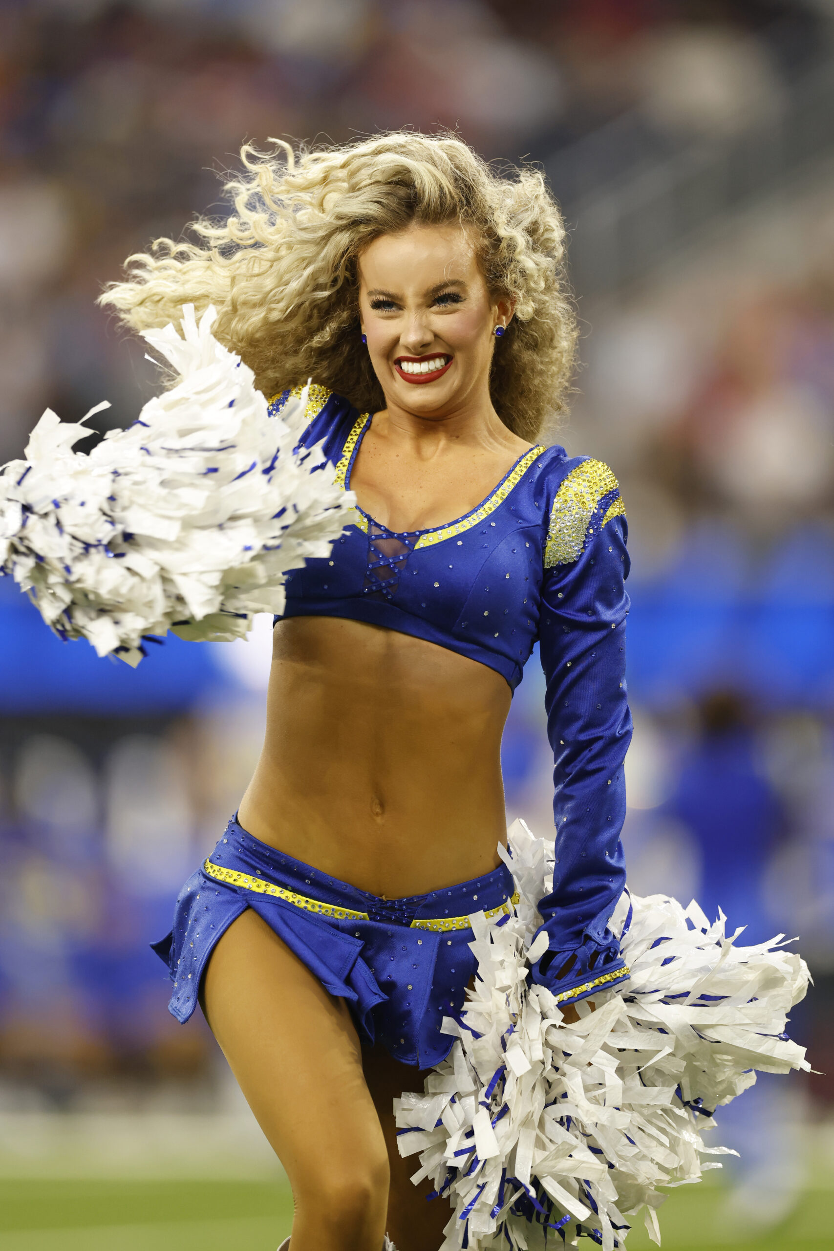 A Rams cheerleader performs during the first half of a...