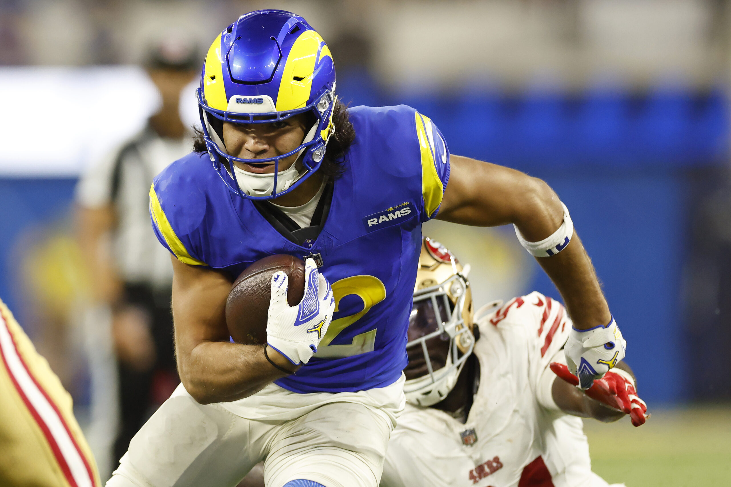 Rams wide receiver Puka Nacua runs the ball during the...