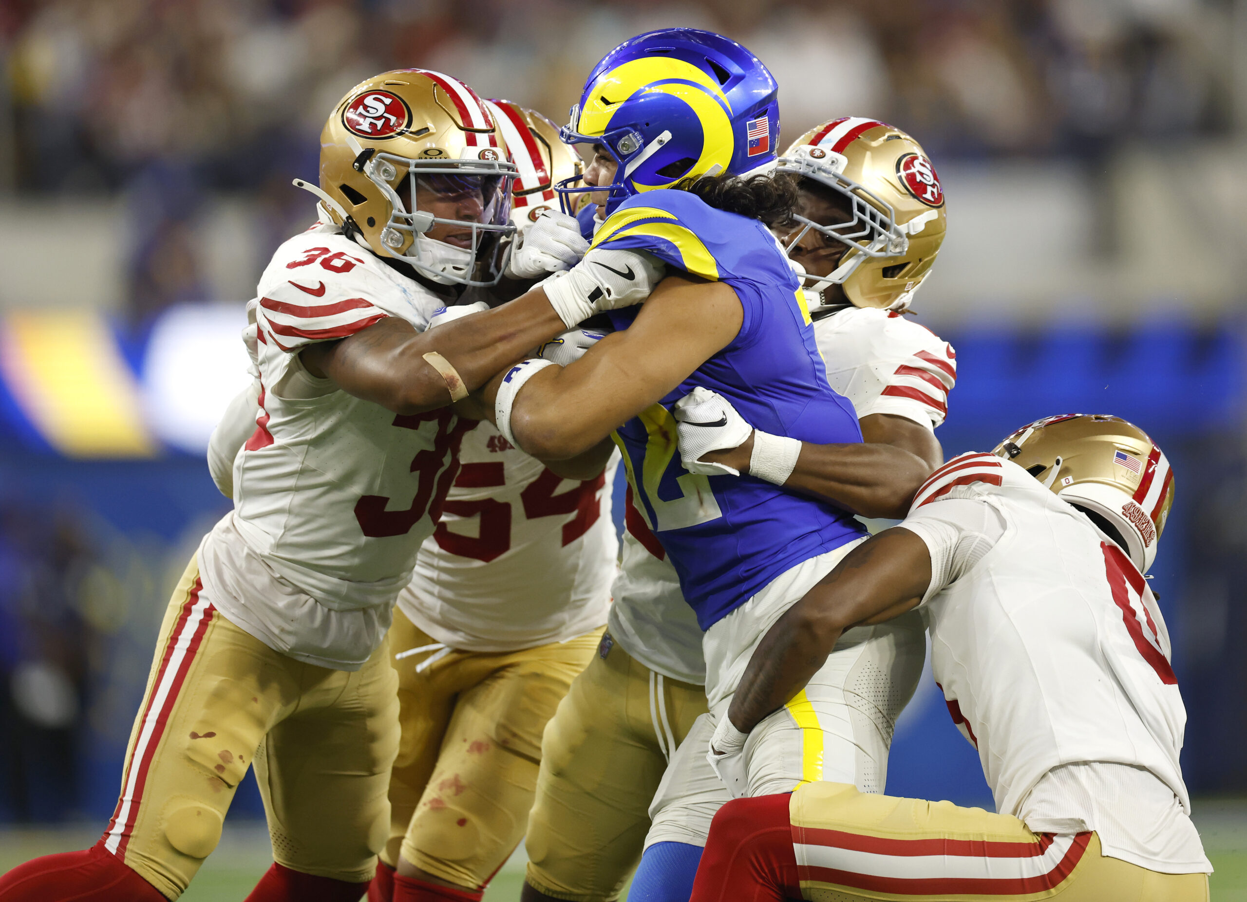 Rams wide receiver Puka Nacua (12) is hit by the...