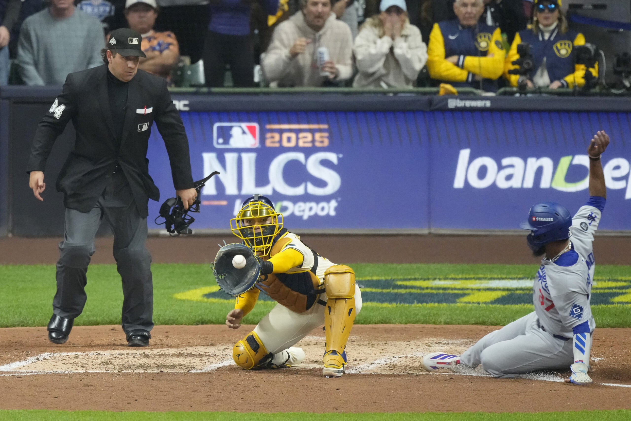 The Dodgers’ Teoscar Hernández, right, is forced out at home...