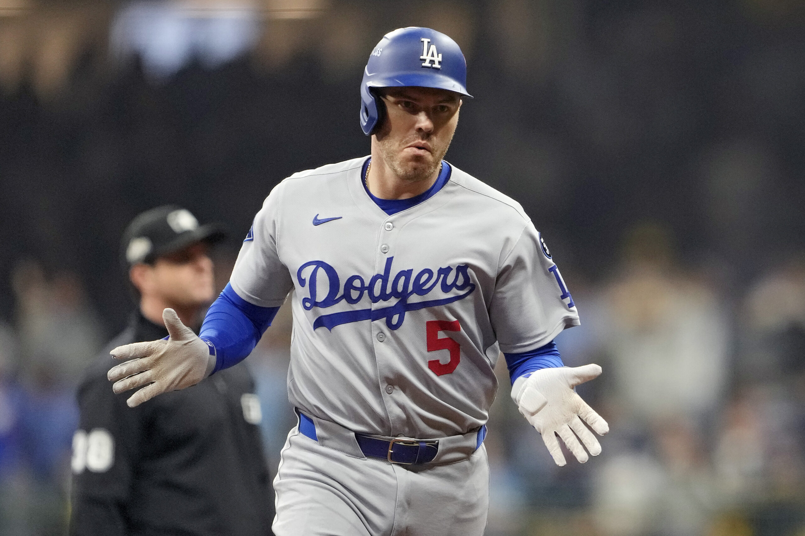 The Dodgers’ Freddie Freeman gestures as he runs the bases...