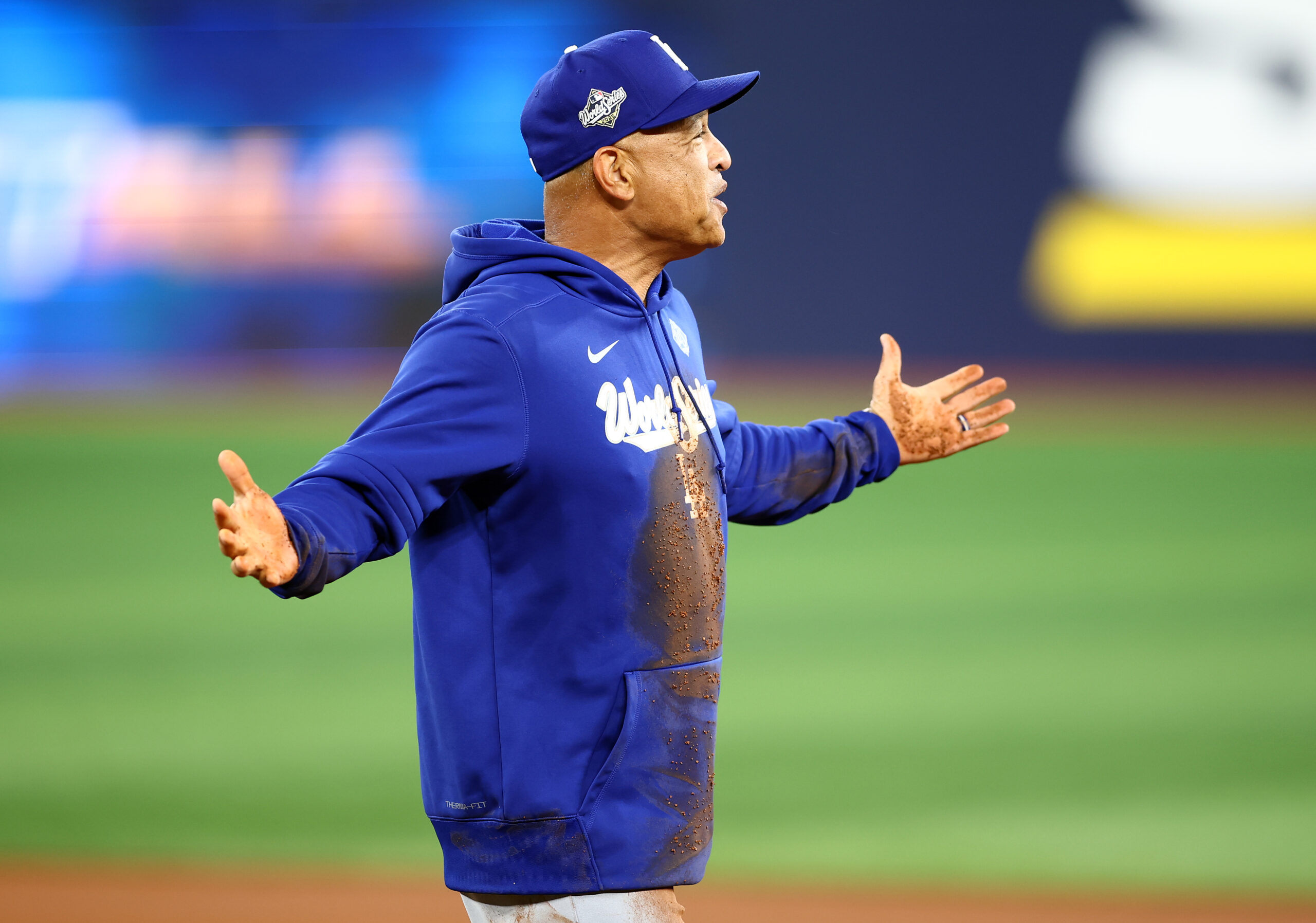 Dodgers manager Dave Roberts reacts after wiping out and falling...