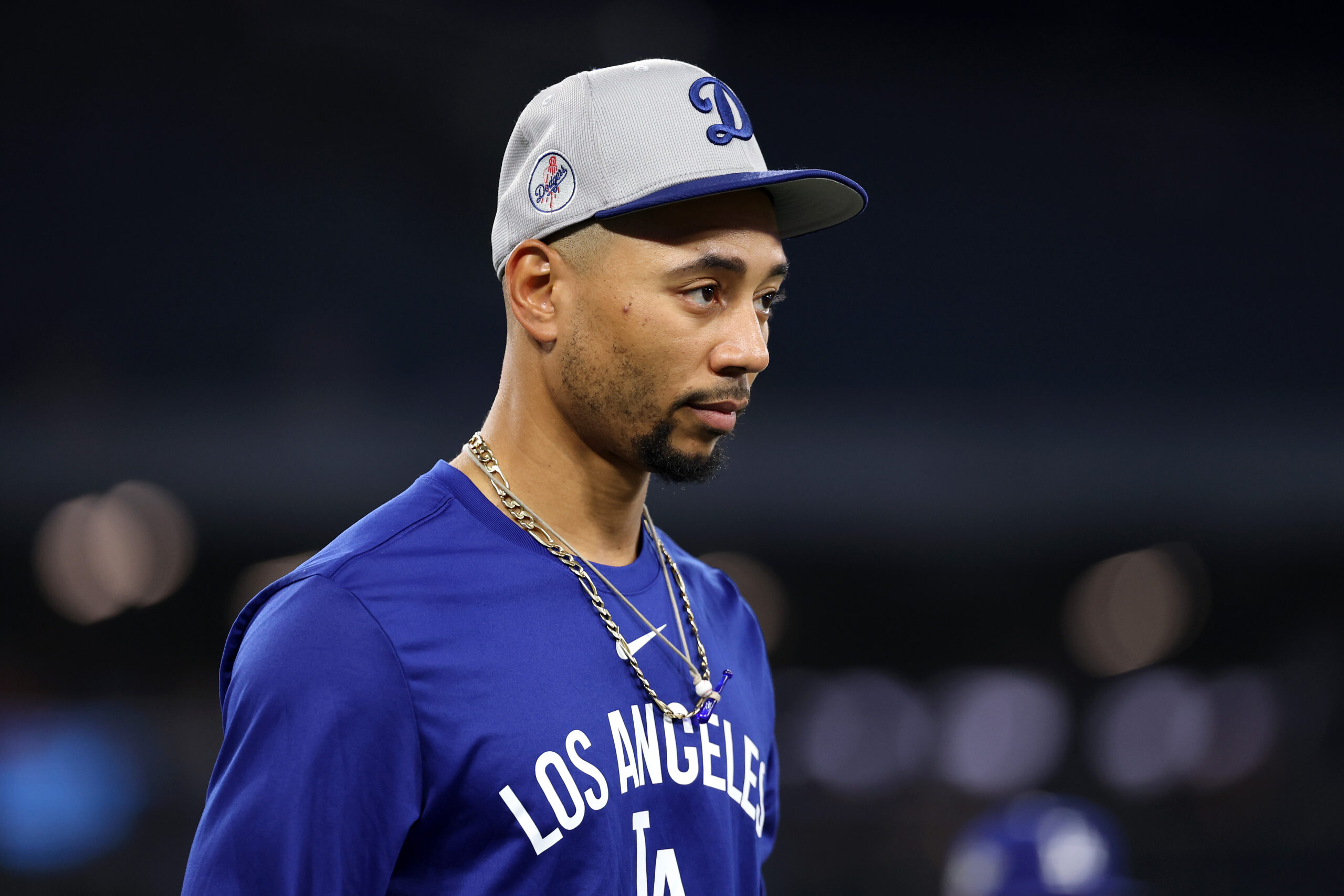 Dodgers shortstop Mookie Betts looks on as the team warms...