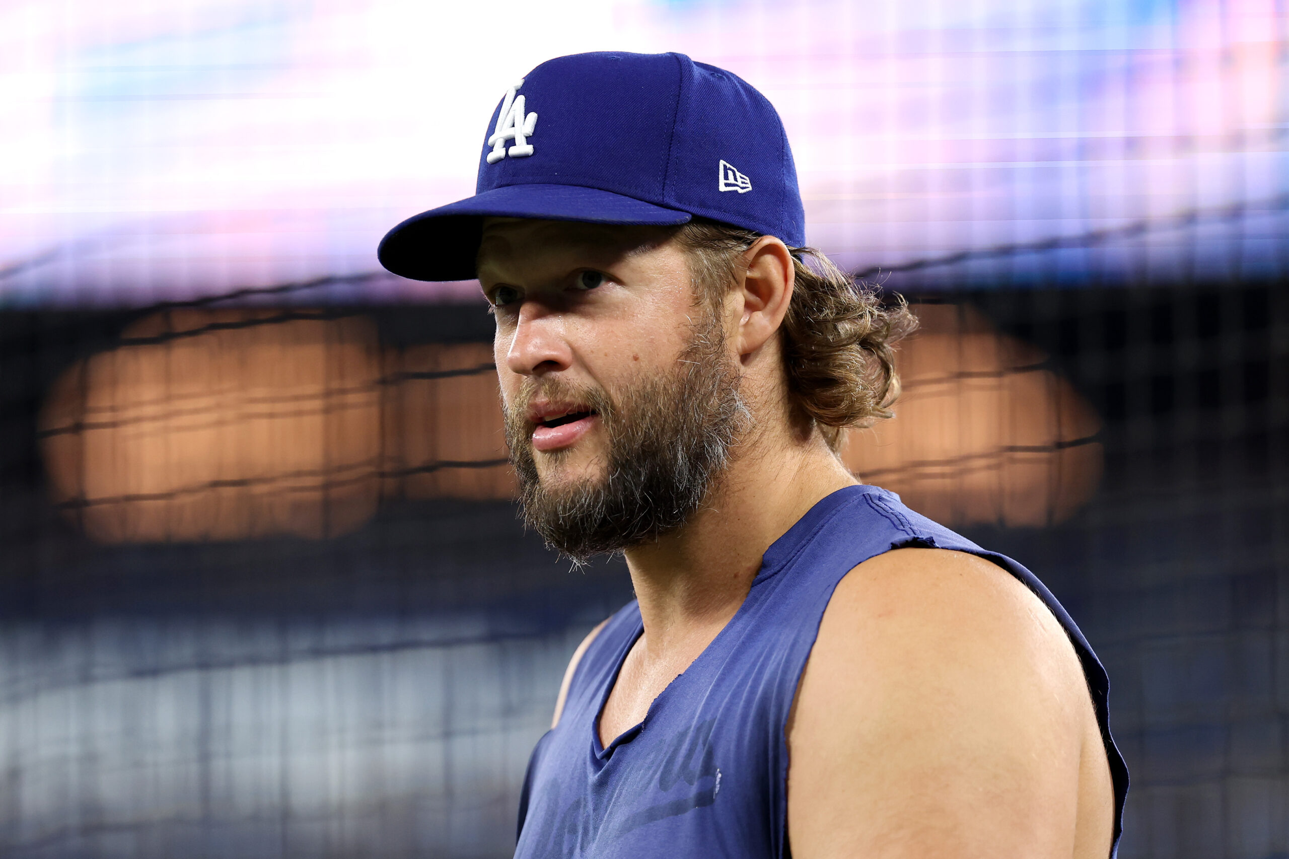 Dodgers pitcher Clayton Kershaw looks on as the team warms...