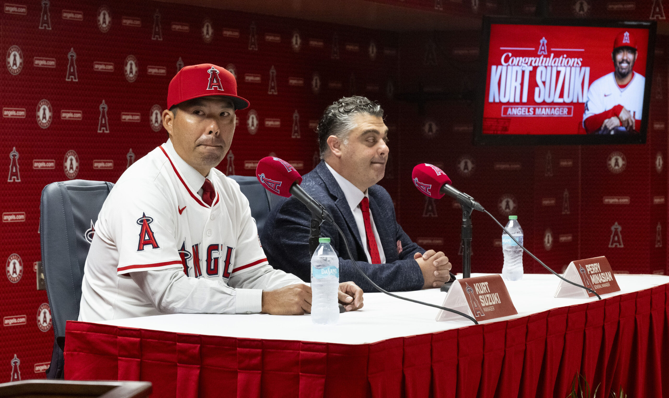 New Angels manager Kurt Suzuki, left, speaks to the media...