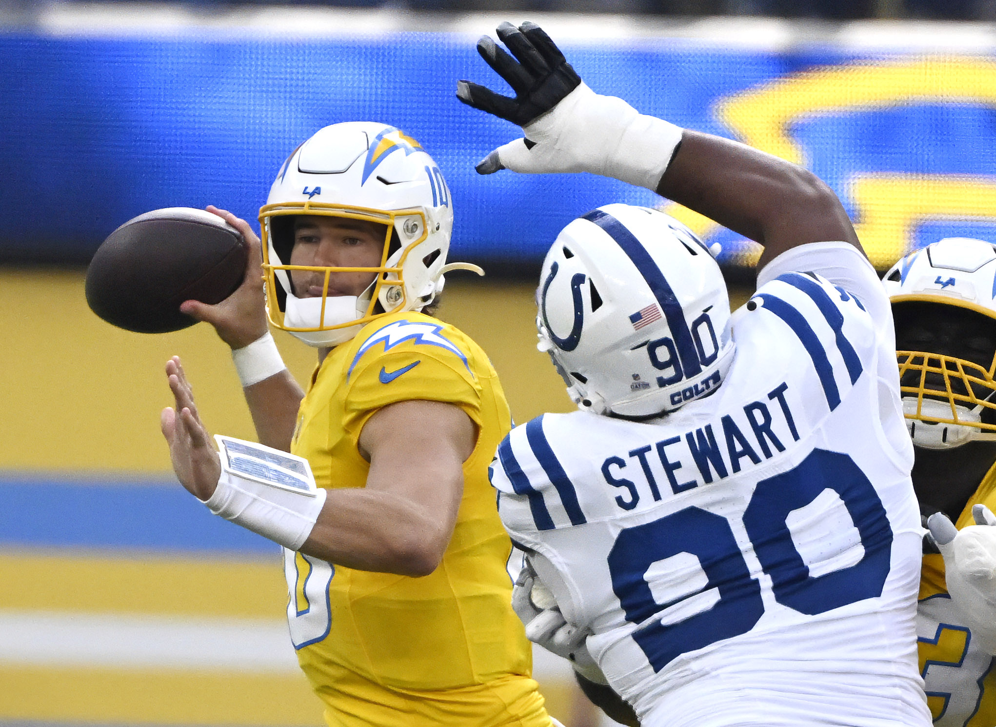 Quarterback Justin Herbert #10 of the Chargers psses over defensive...