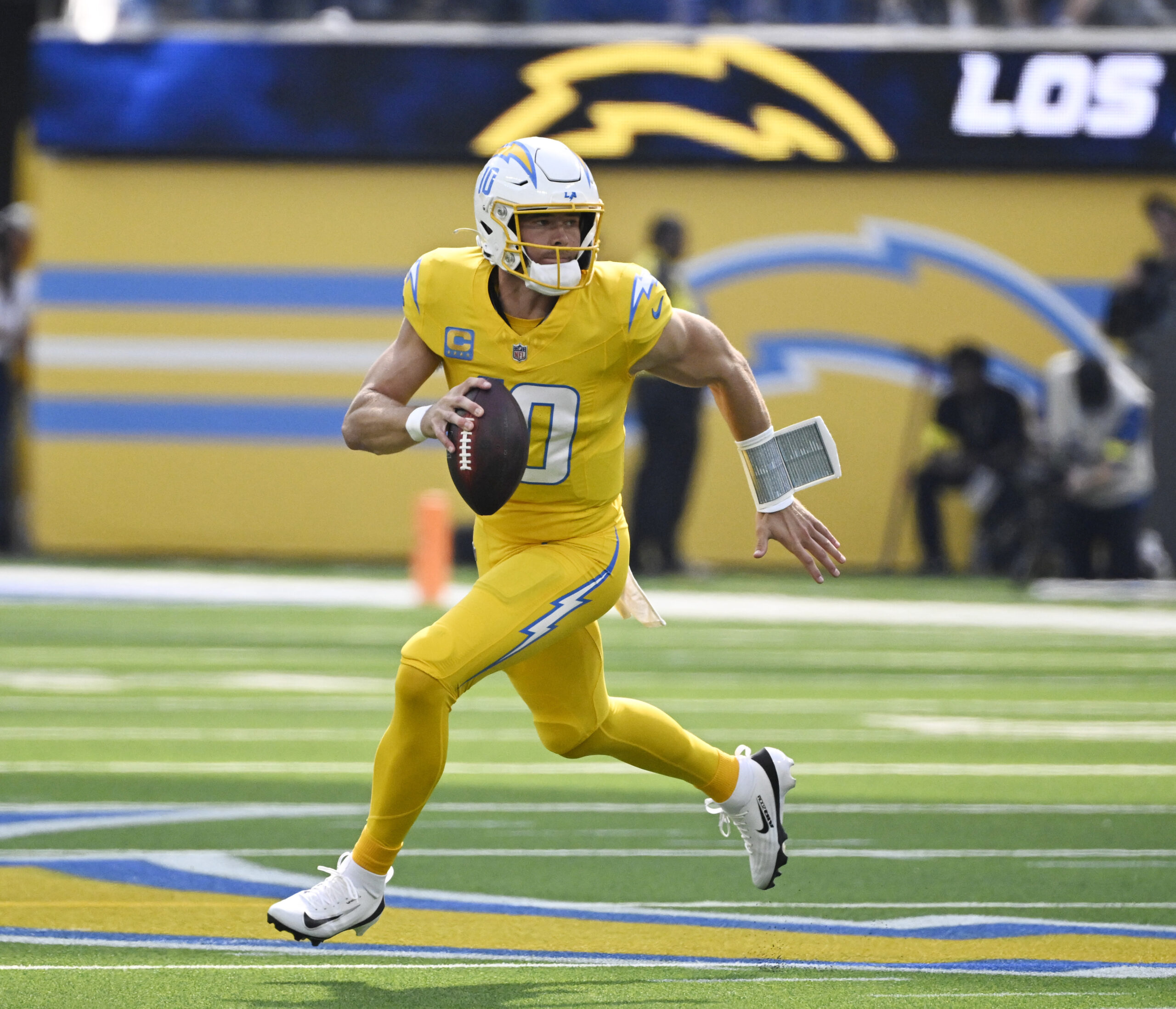Quarterback Justin Herbert #10 of the Chargers scrambles against the...