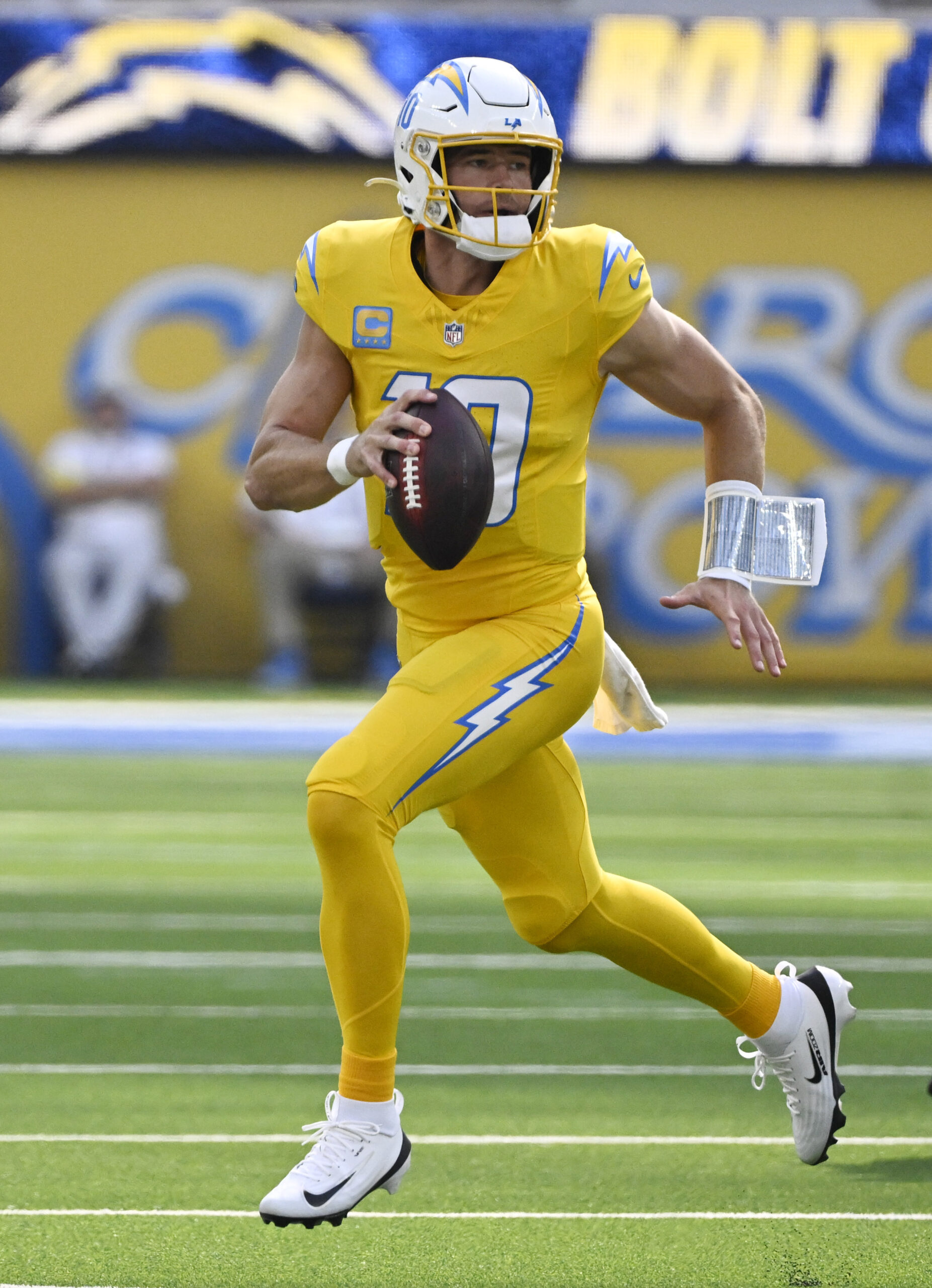 Quarterback Justin Herbert #10 of the Chargers scrambles against the...