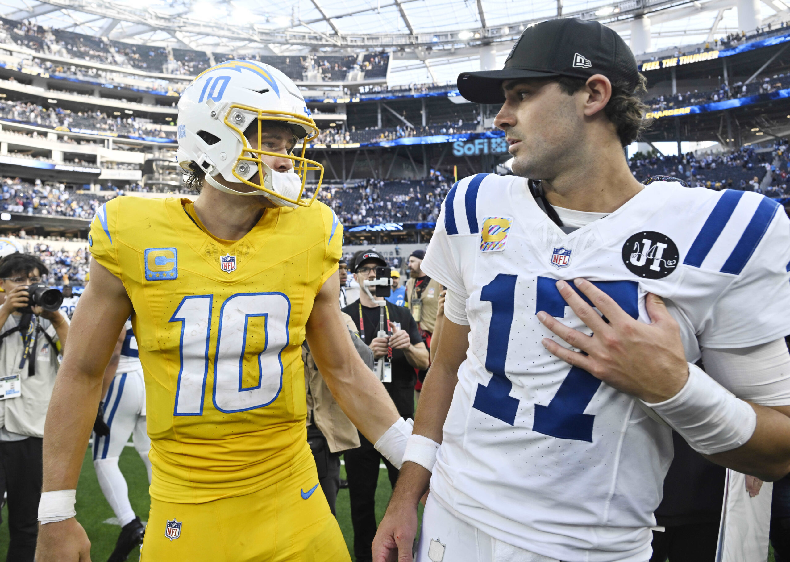 Quarterback Justin Herbert #10 of the Chargers with quarterback Daniel...
