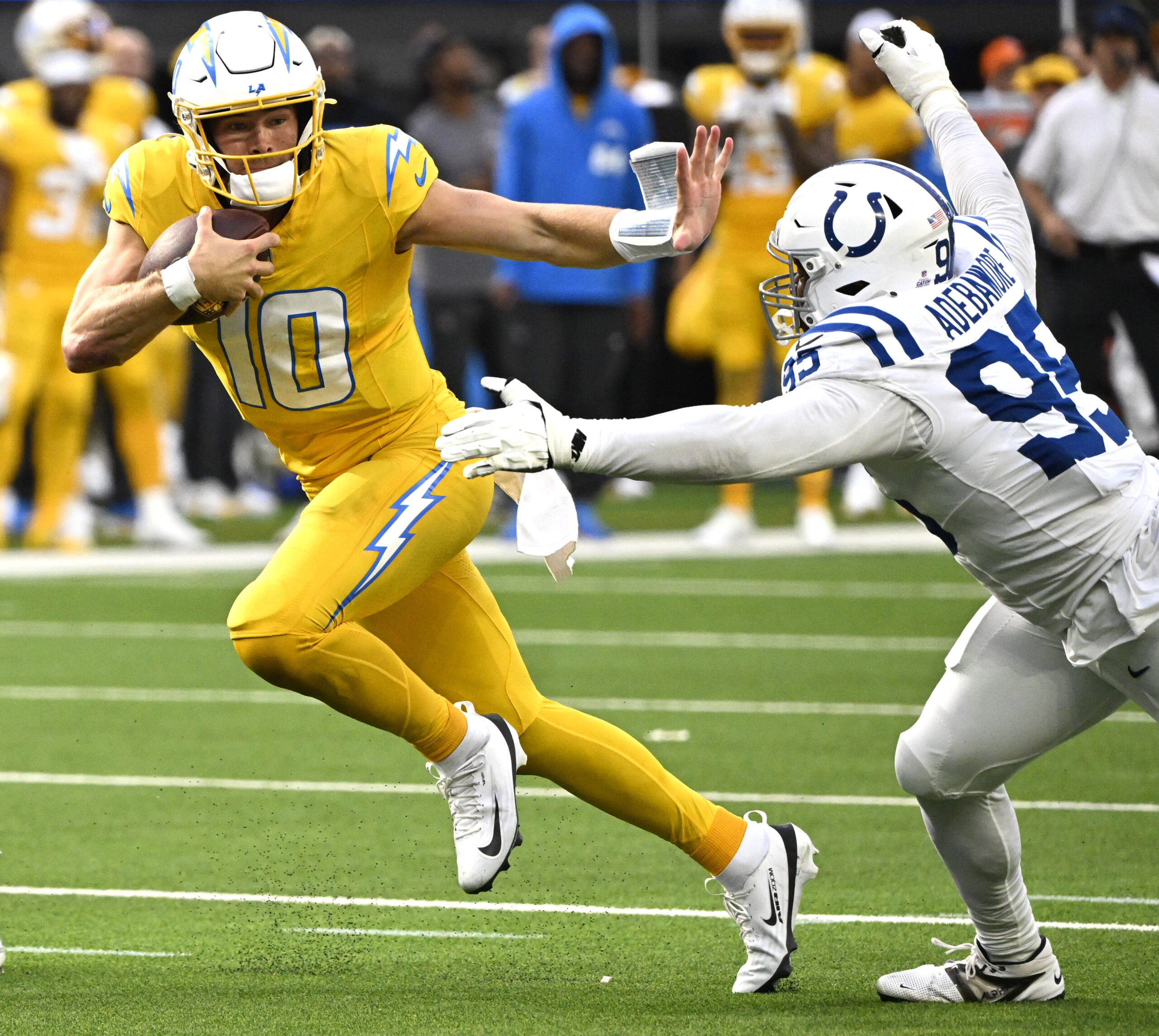 Quarterback Justin Herbert #10 of the Chargers runs for a...