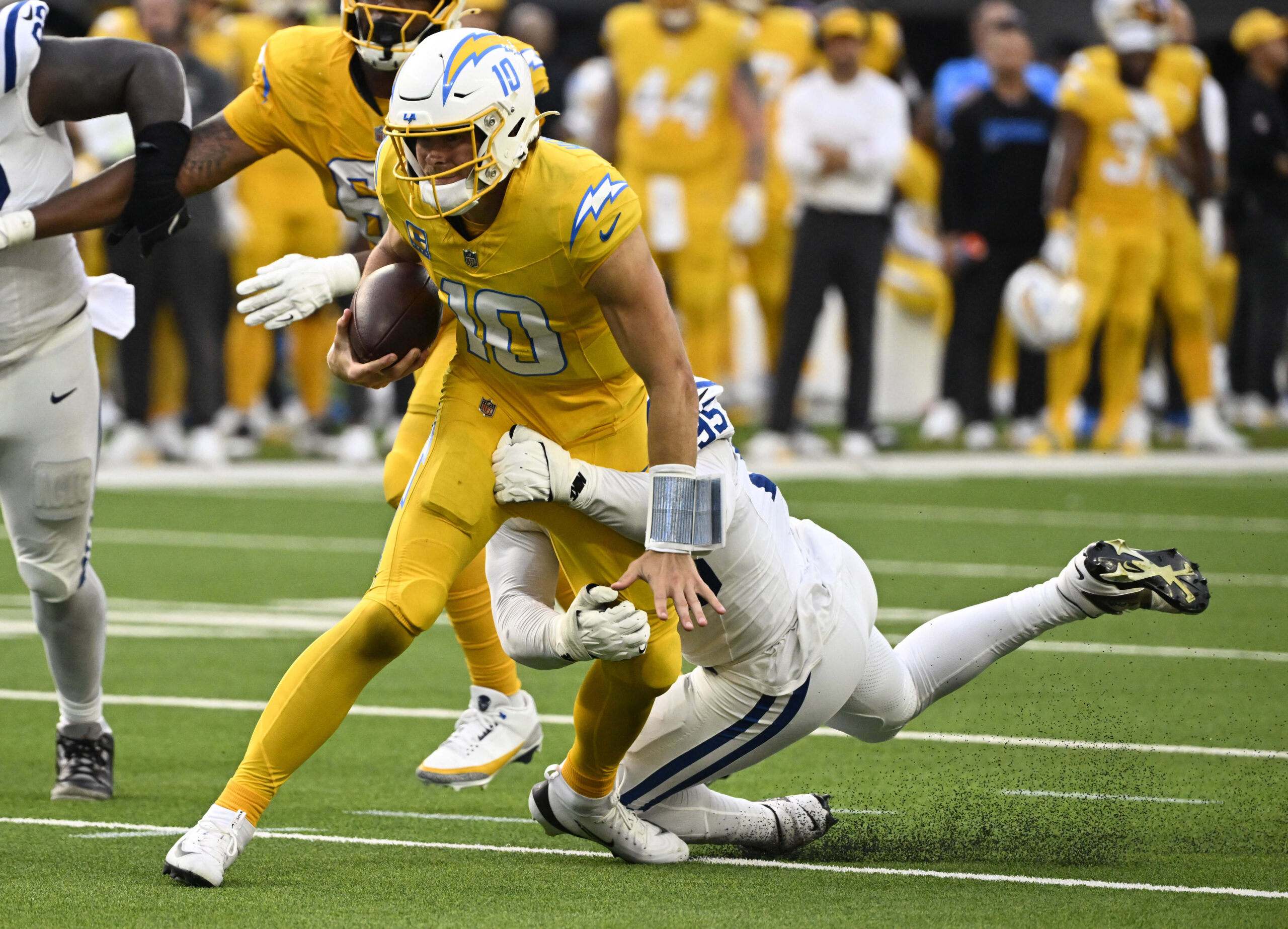 Quarterback Justin Herbert #10 of the Chargers runs for a...