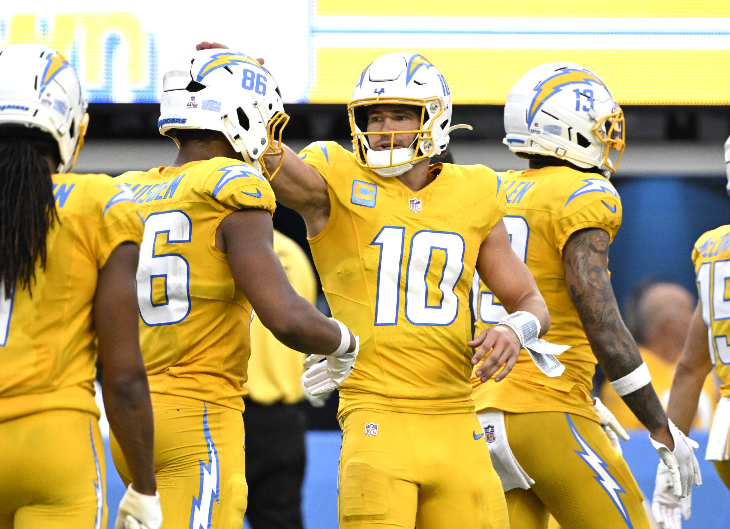 Quarterback Justin Herbert #10 celebrates with teammate tight end Oronde...