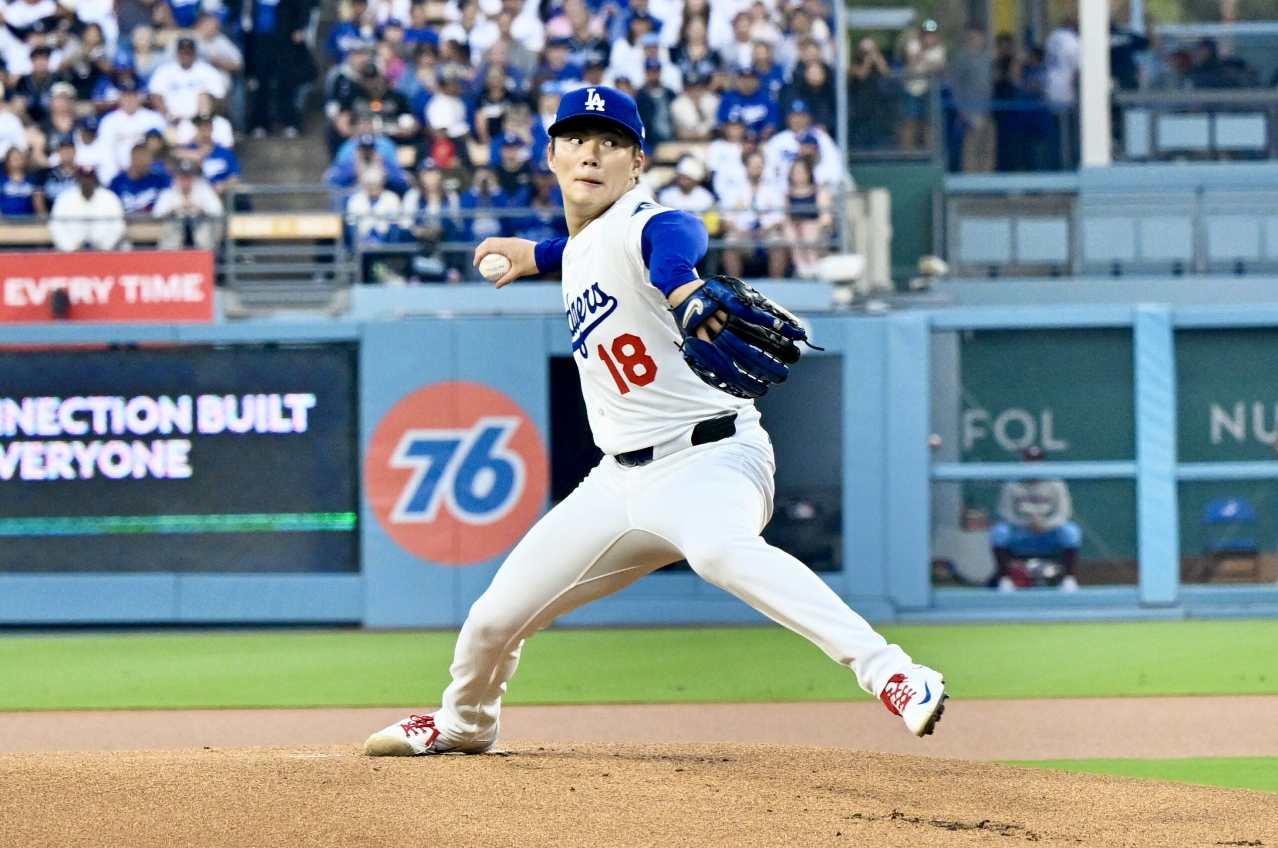 Dodgers starting pitcher Yoshinobu Yamamoto throws to the plate during...