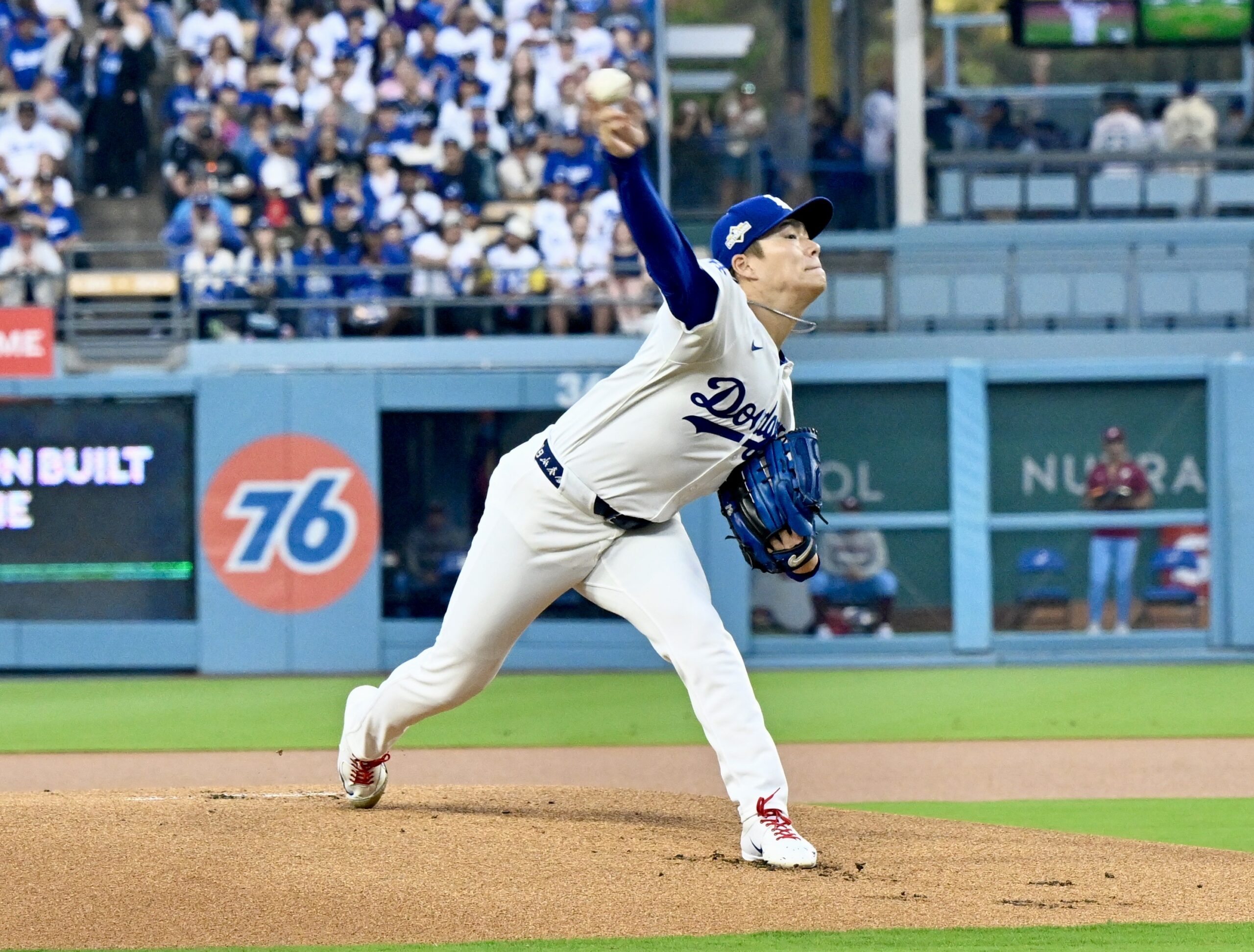 Dodgers starting pitcher Yoshinobu Yamamoto throws to the plate during...