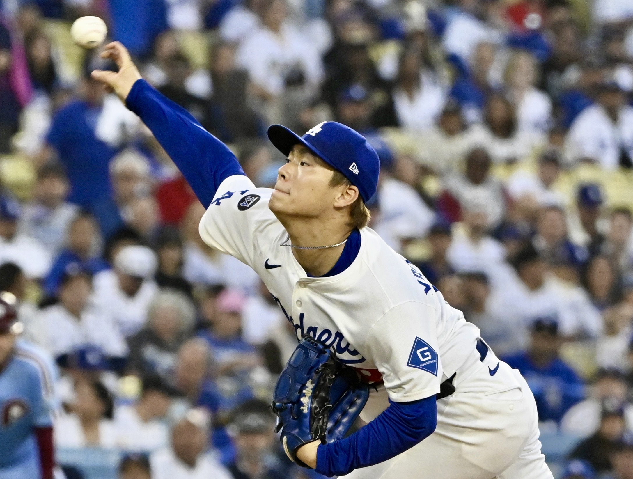 Dodgers starting pitcher Yoshinobu Yamamoto throws to the plate during...