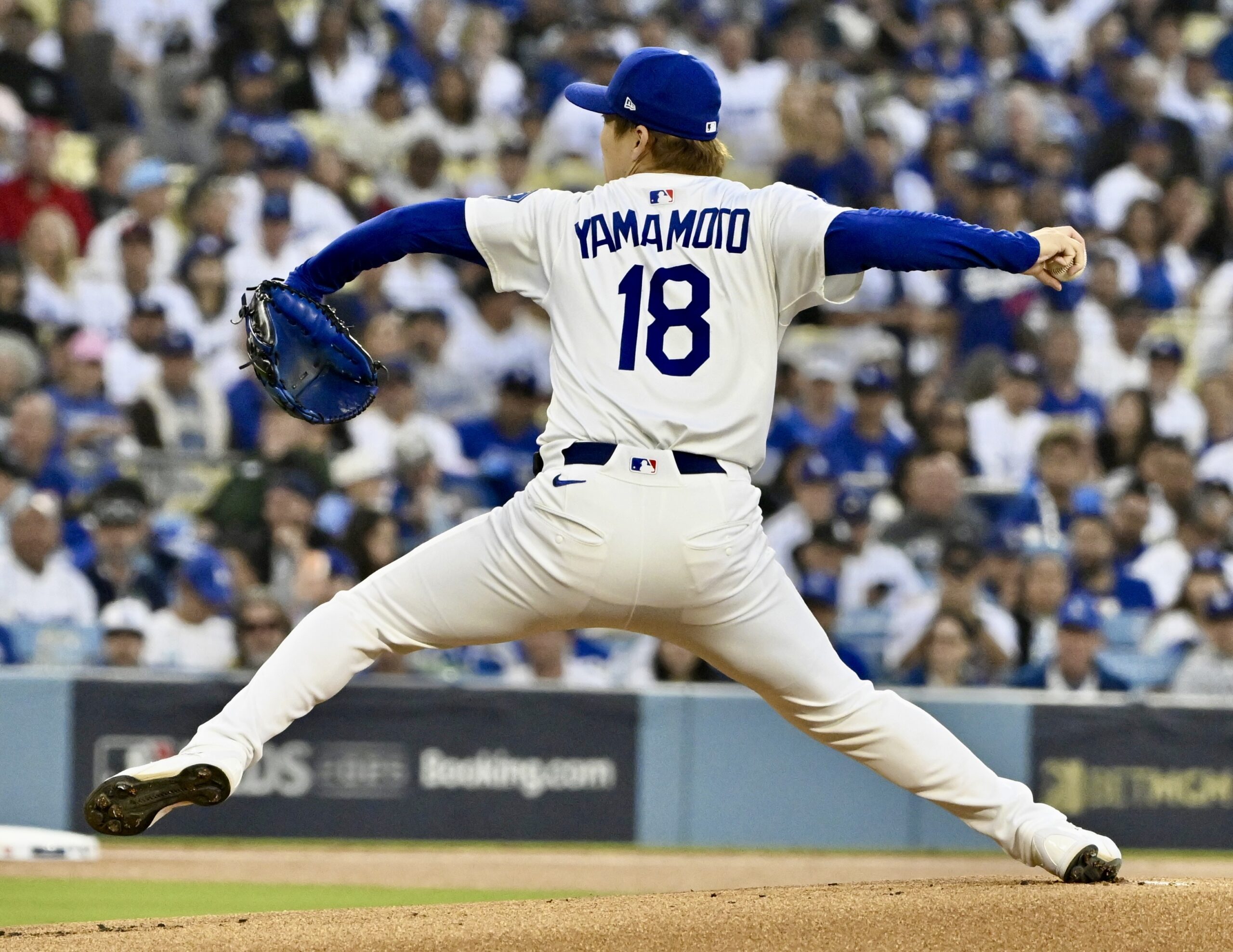 Dodgers starting pitcher Yoshinobu Yamamoto throws to the plate during...