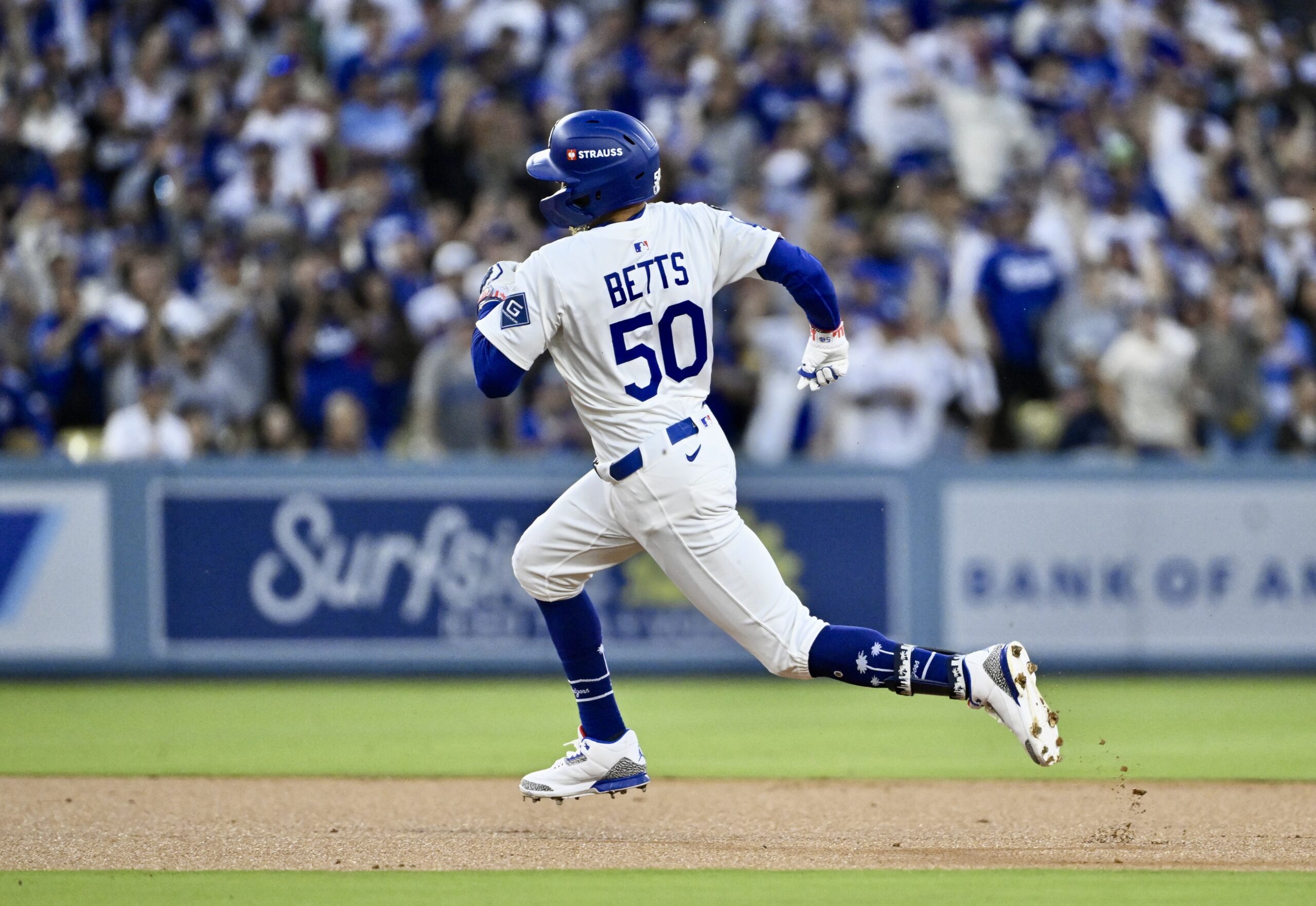 The Dodgers’ Mookie Betts sprints around the bases on his...