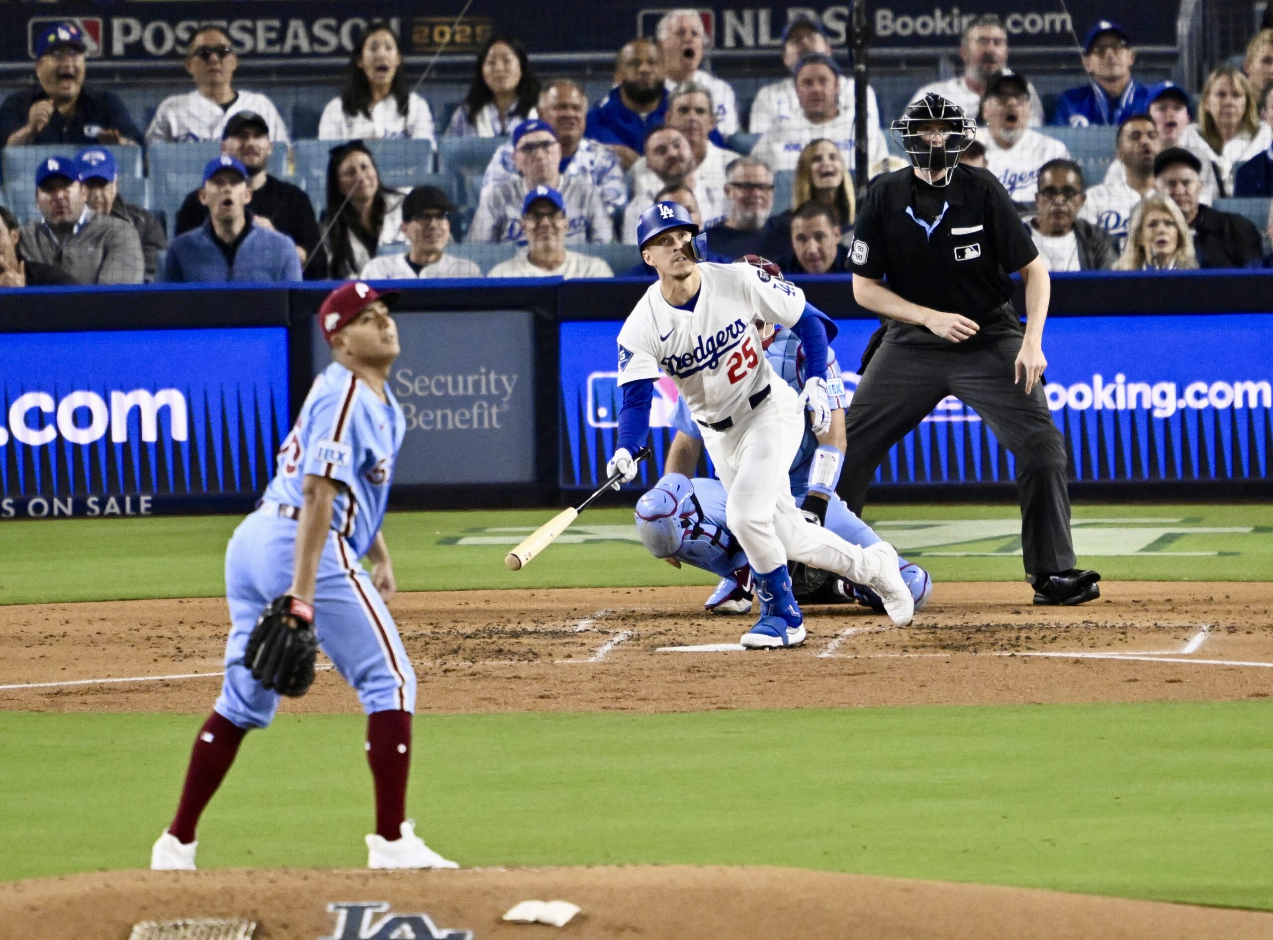 The Dodgers’ Tommy Edman (25) hits a solo home run...