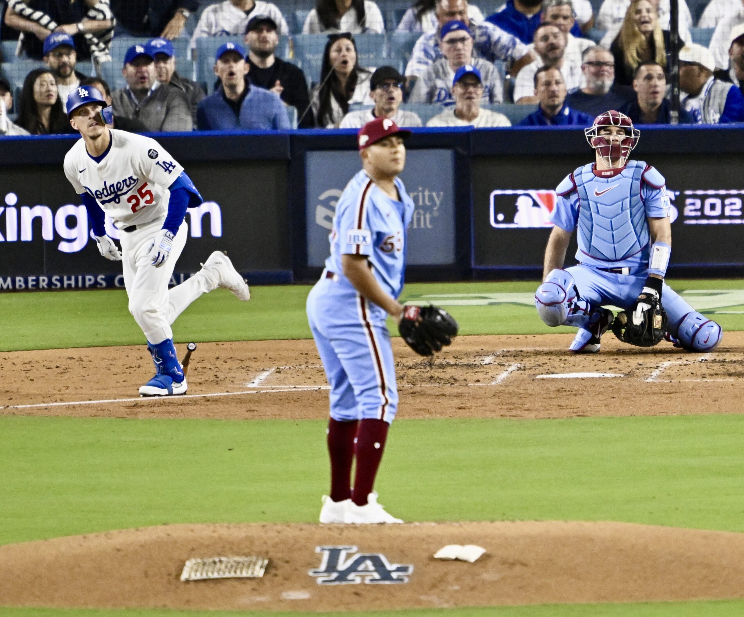 The Dodgers’ Tommy Edman (25) watches the flight of his...