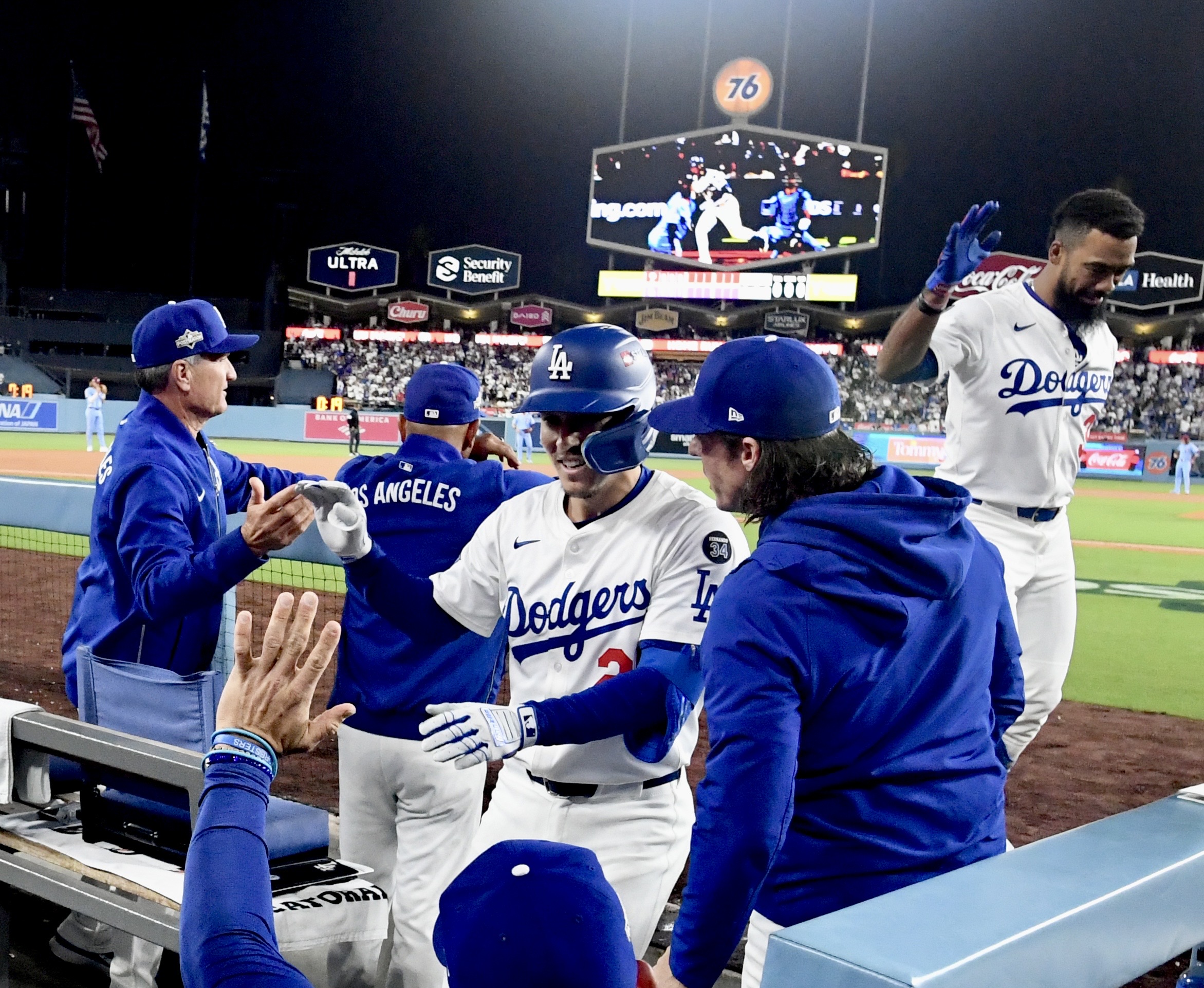The Dodgers’ Tommy Edman (25) celebrates with teammates as he...