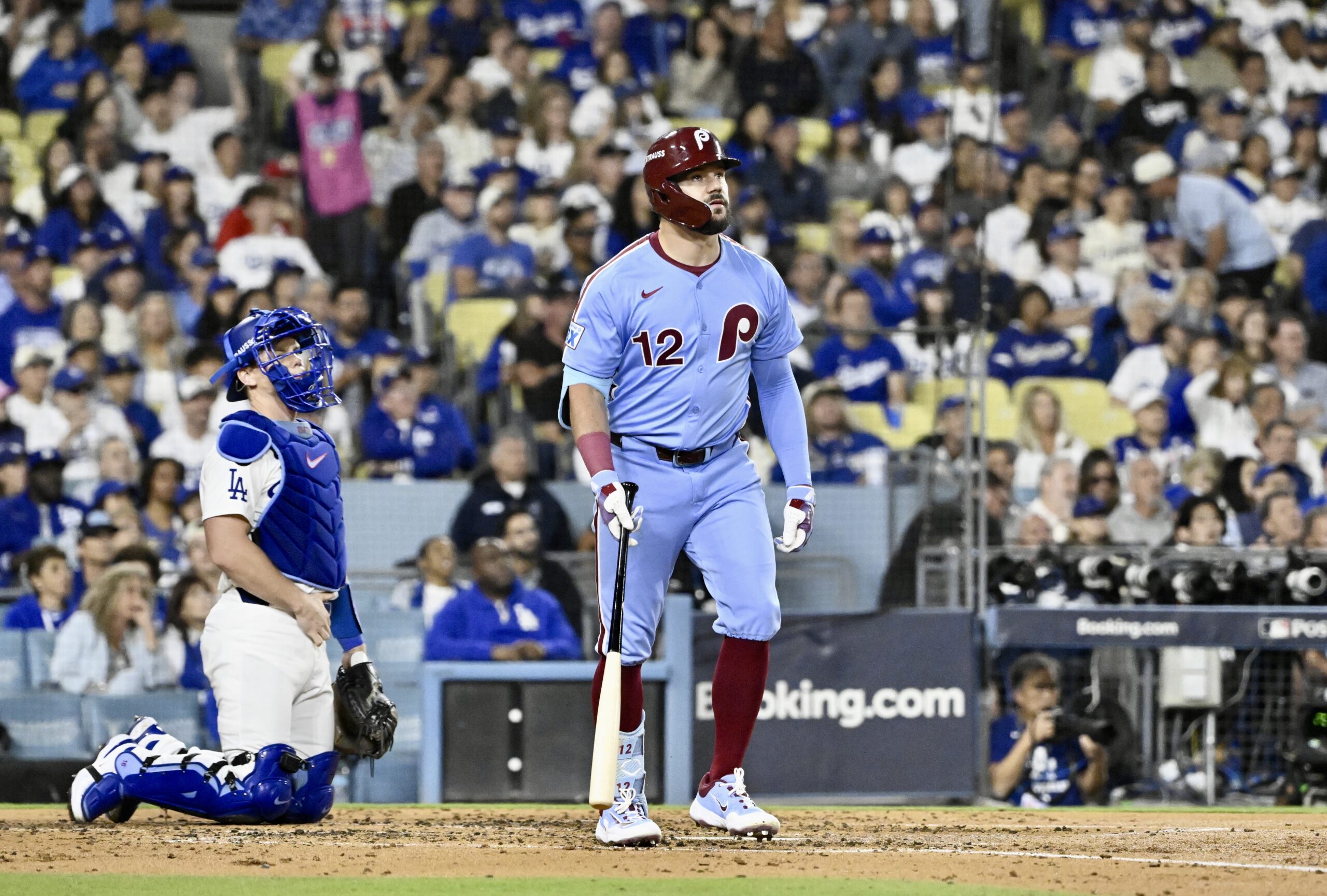 Philadelphia Phillies slugger Kyle Schwarber watches the flight of his...