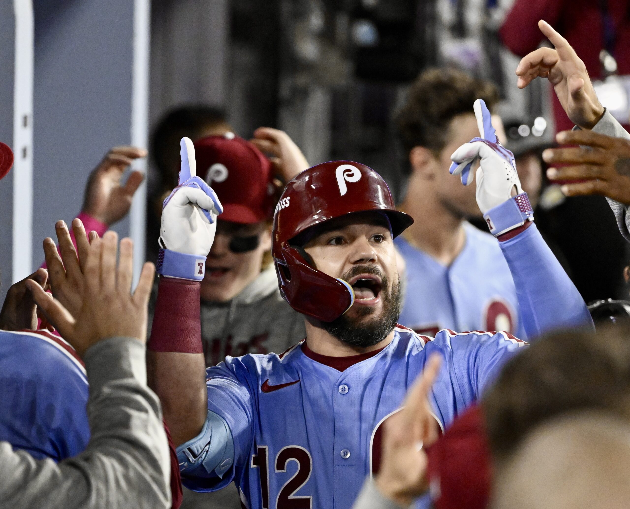 Philadelphia Phillies slugger Kyle Schwarber celebrates in the dugout after...
