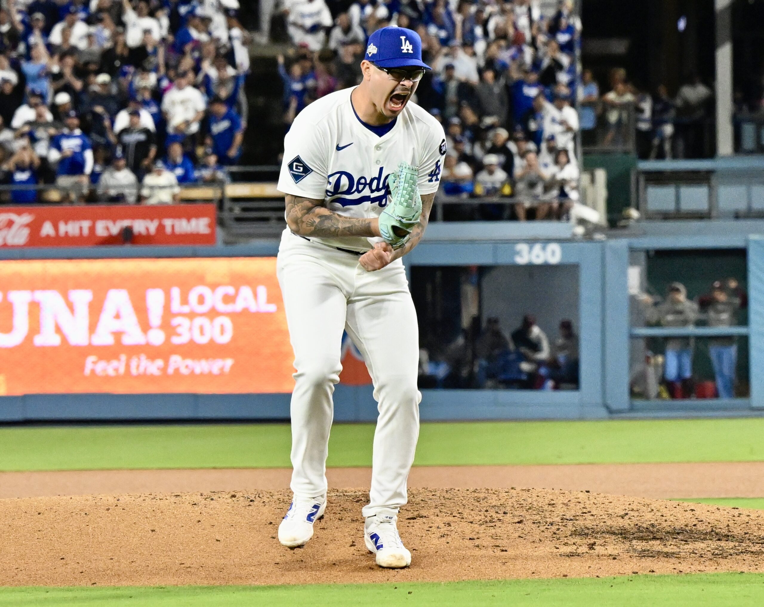 Dodgers relief pitcher Anthony Banda reacts after striking out the...