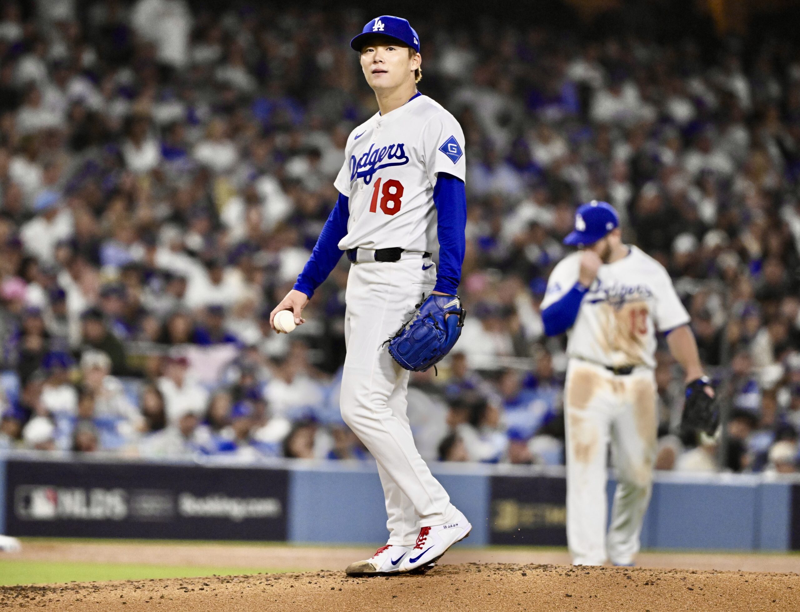 Dodgers starting pitcher Yoshinobu Yamamoto reacts after giving up back-to-back...