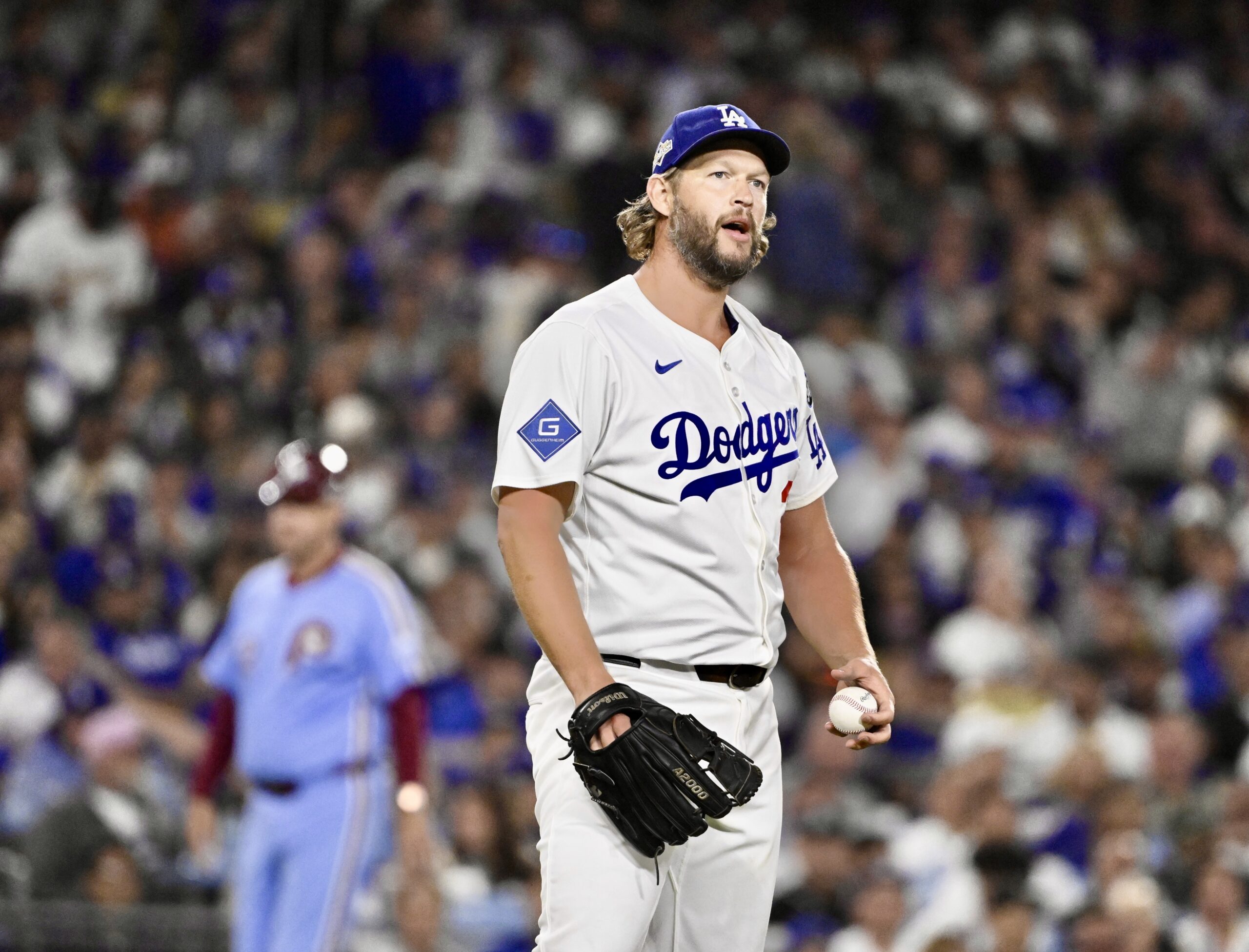 Dodgers relief pitcher Clayton Kershaw reacts after walking Philadelphia Phillies...