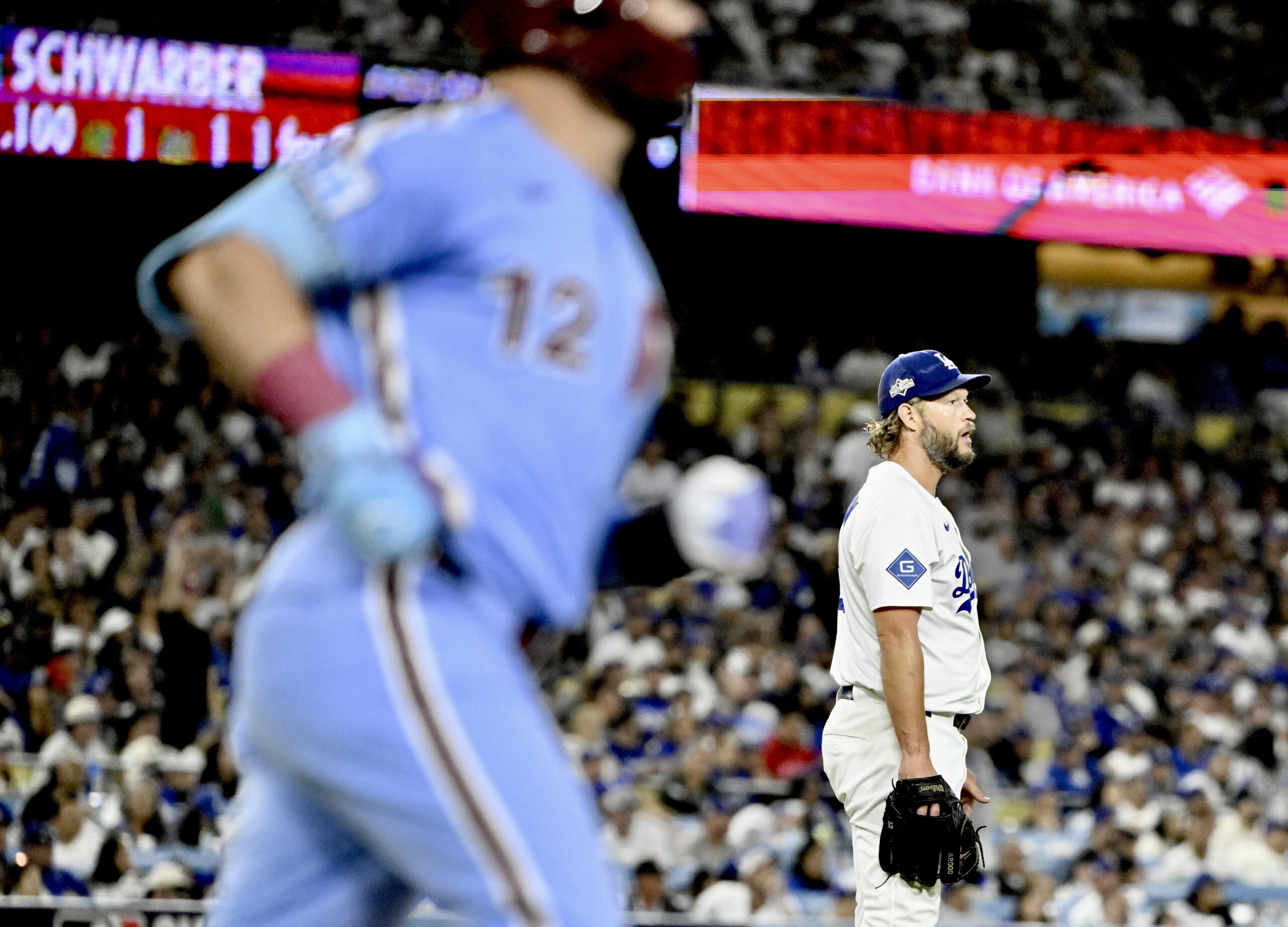 Dodgers relief pitcher Clayton Kershaw reacts after giving up a...