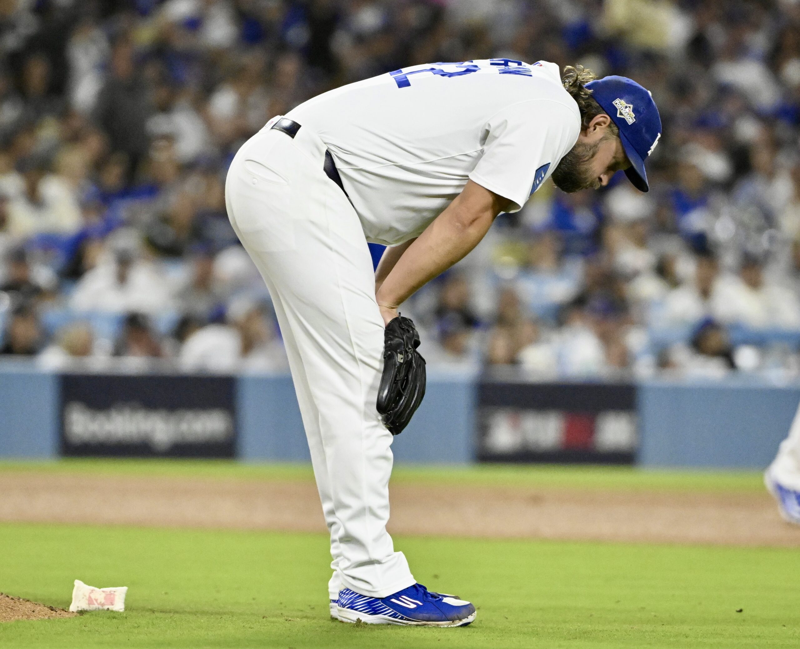Dodgers relief pitcher Clayton Kershaw reacts after giving up a...