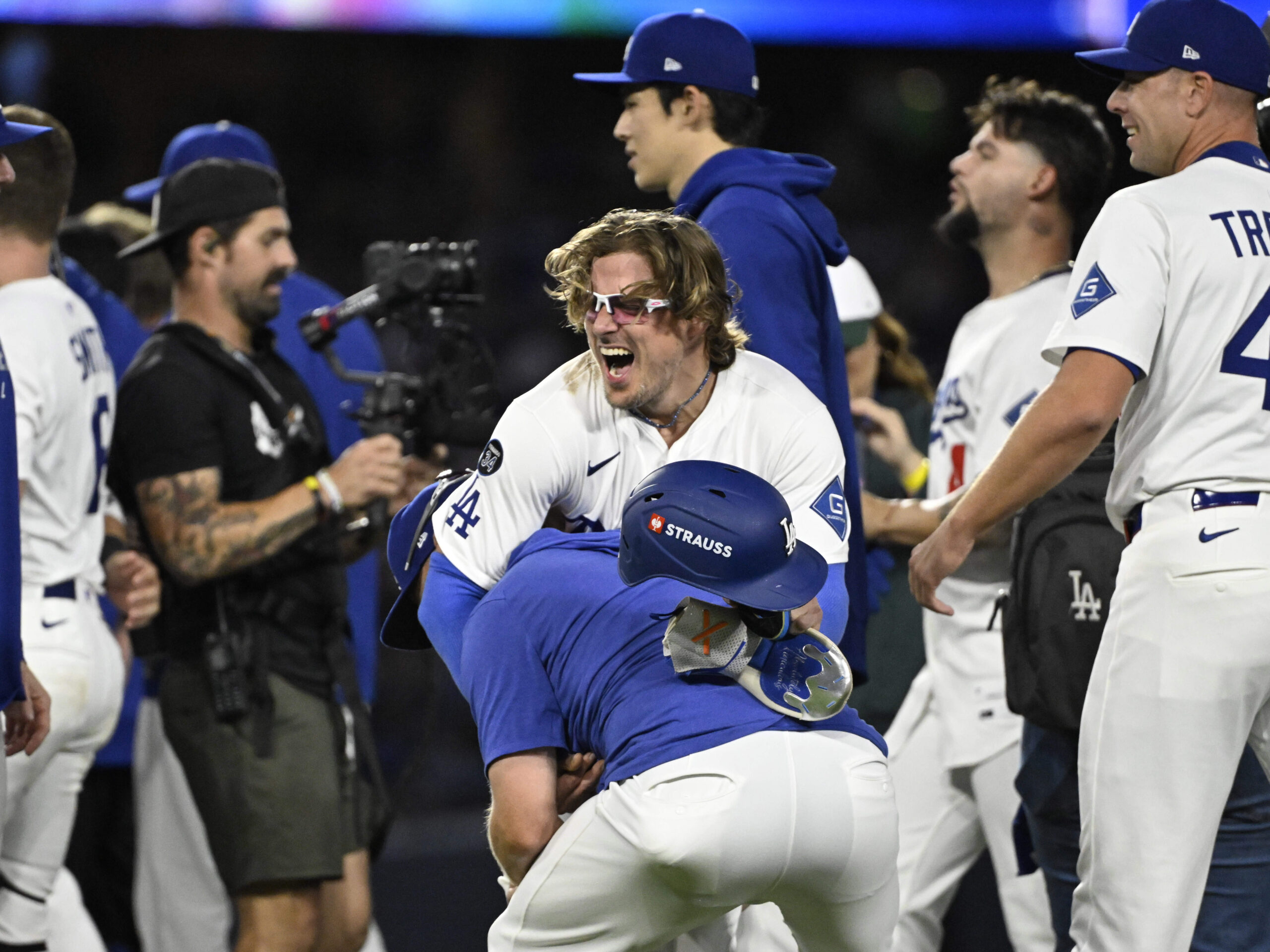 The Dodgers’ Kike Hernández, center, celebrates after their 2-1, 11-inning...