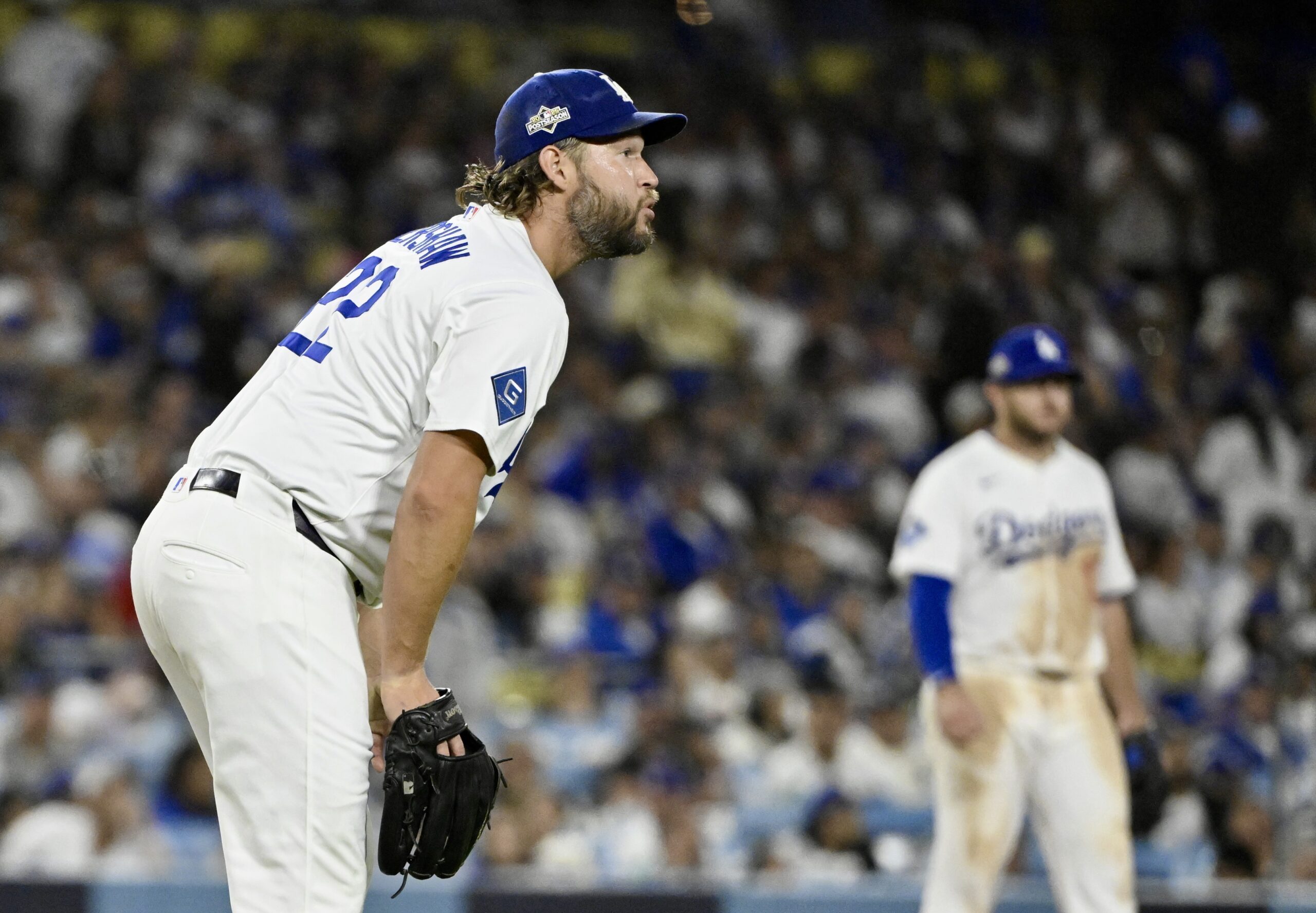 Dodgers relief pitcher Clayton Kershaw reacts after giving up a...