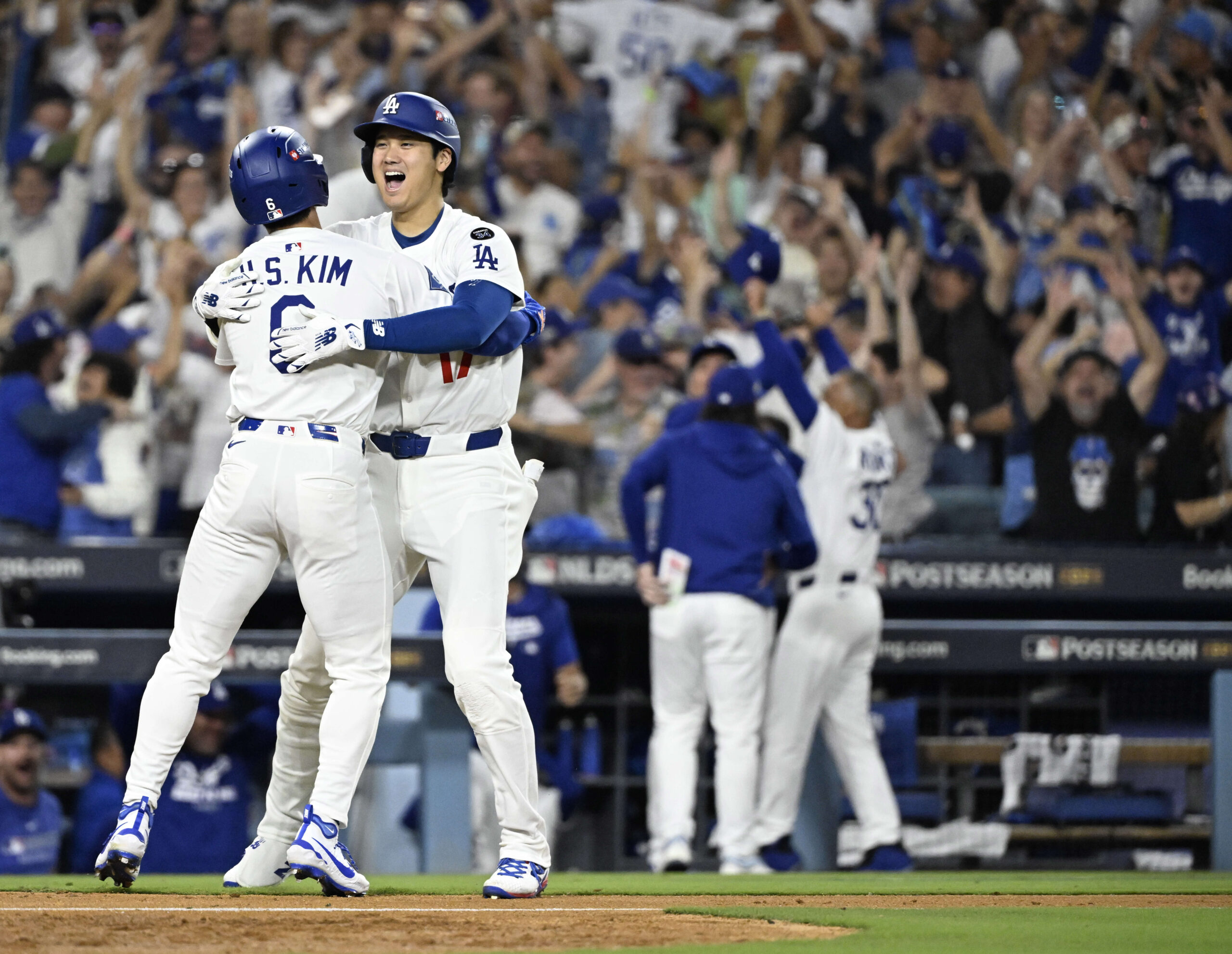 Shohei Ohtani, left, celebrates with teammate Hyeseong Kim #6 of...