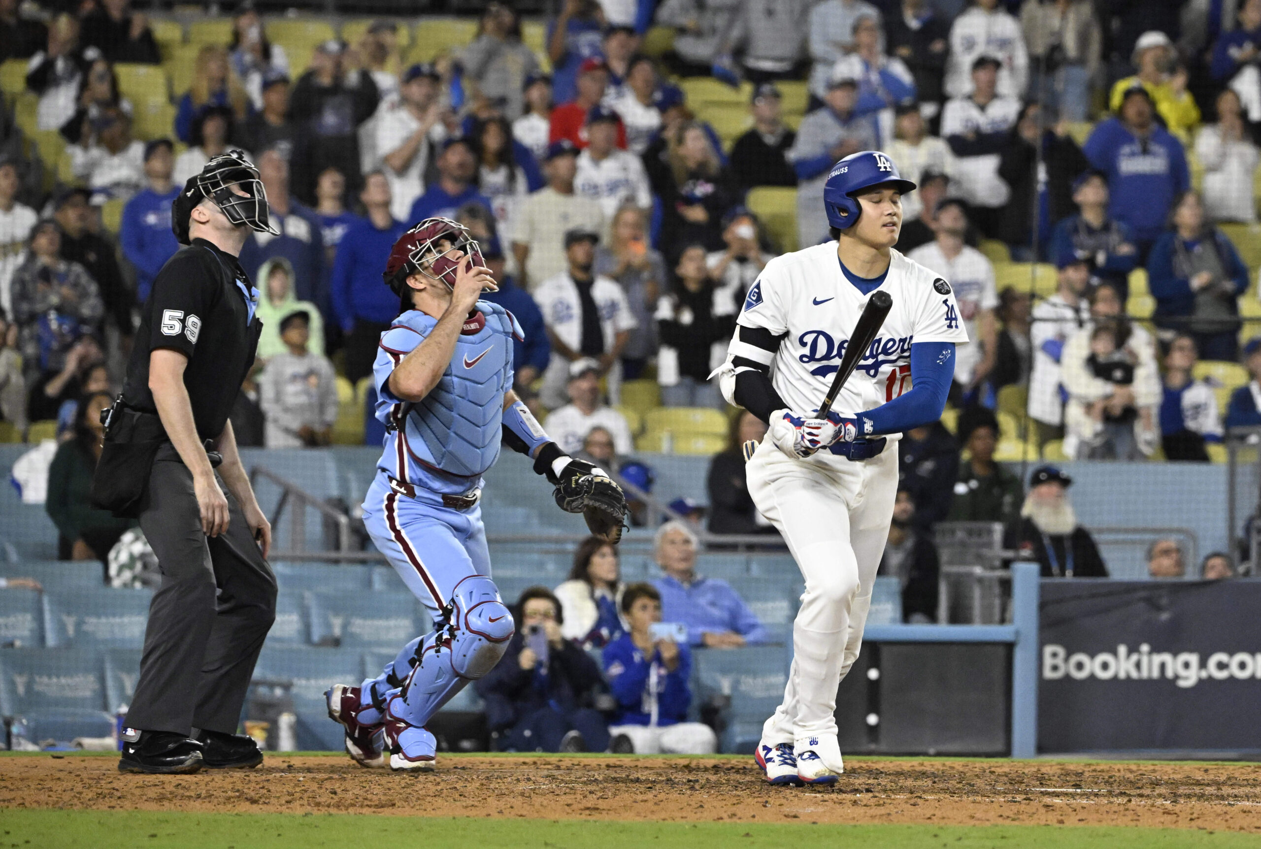 Dodgers star Shohei Ohtani watches his fly ball out in...