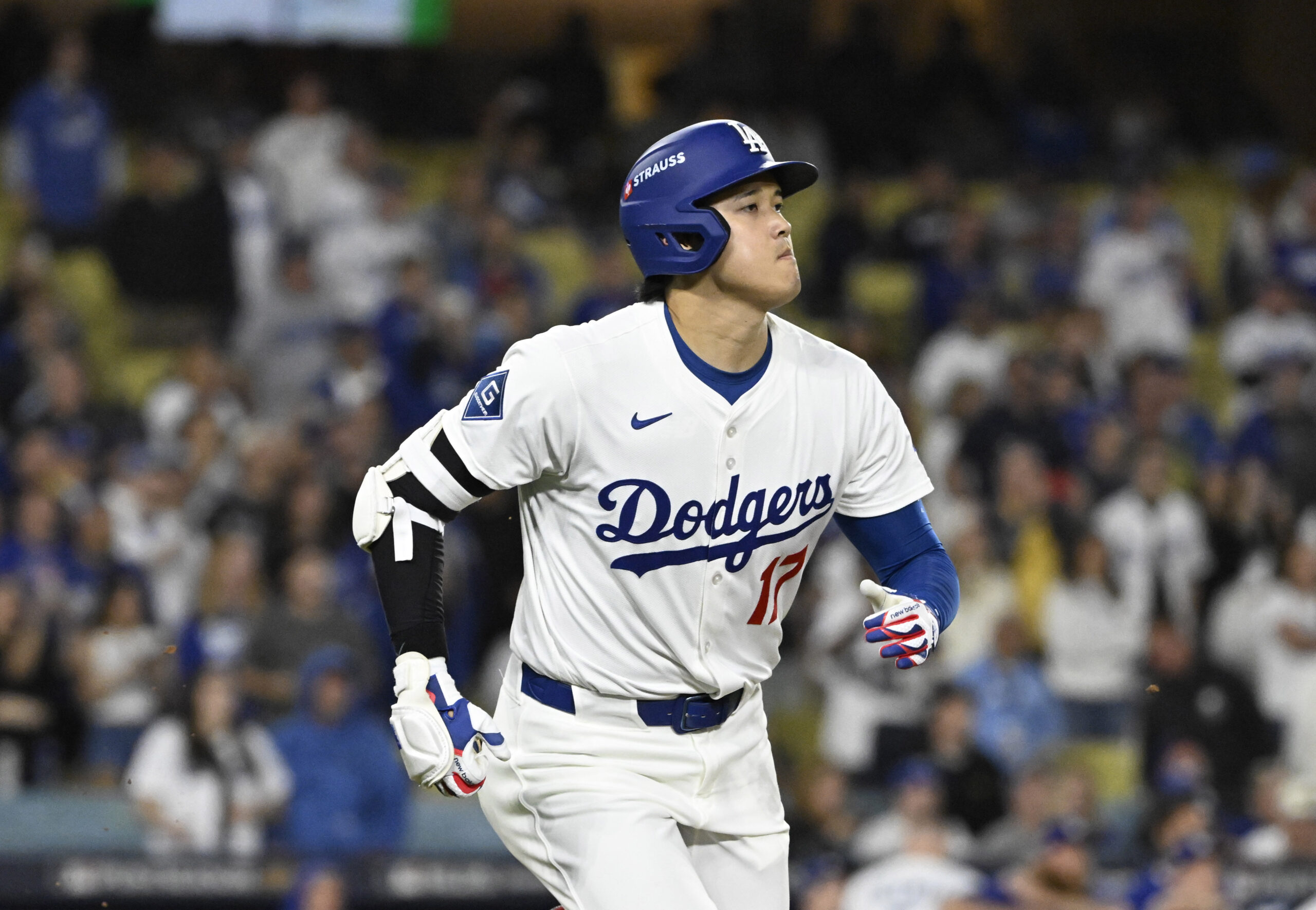 Dodgers star Shohei Ohtani watches his fly ball out in...