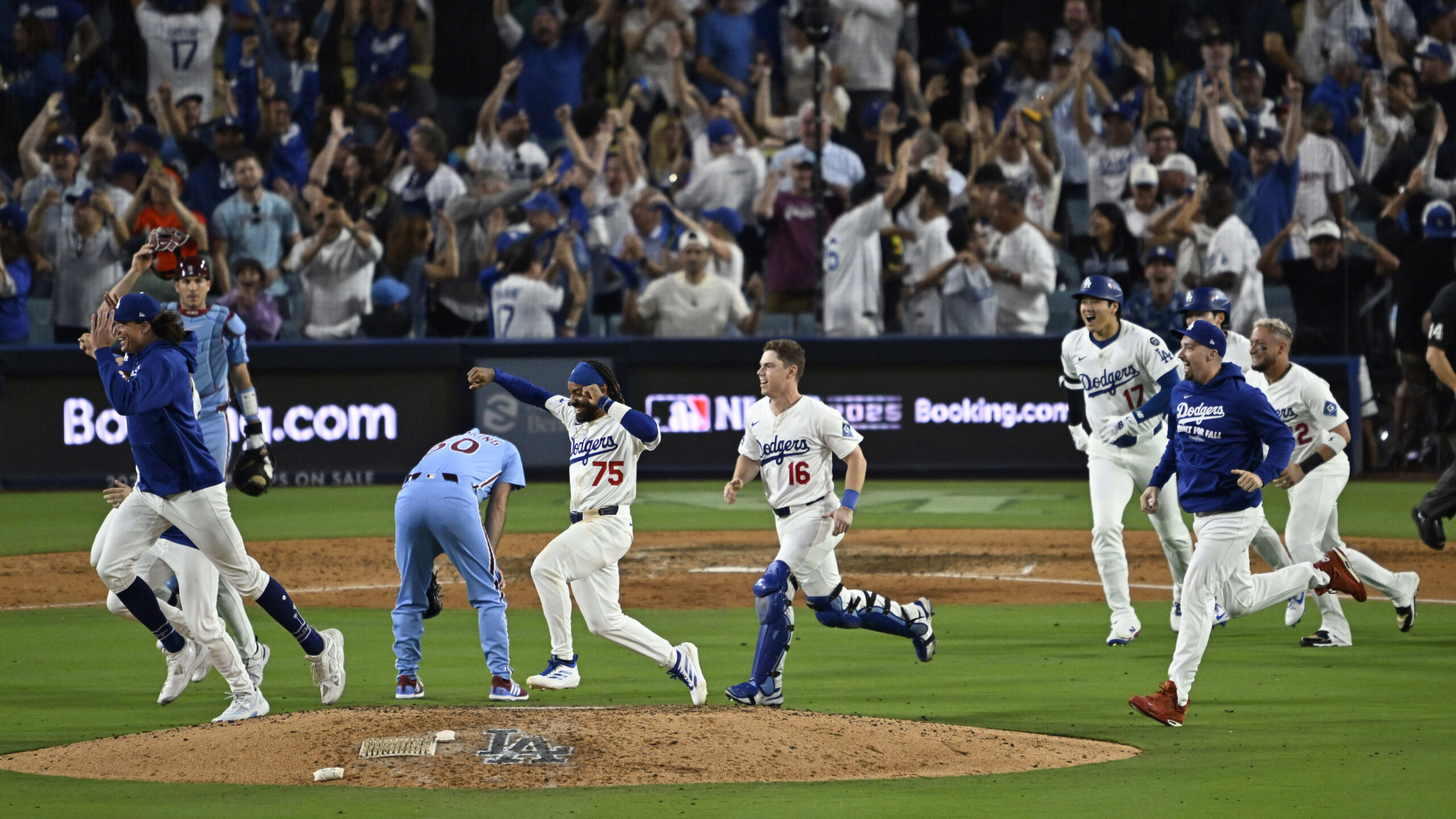 The Dodgers run past Philadelphia Phillies relief pitcher Orion Kerkering...
