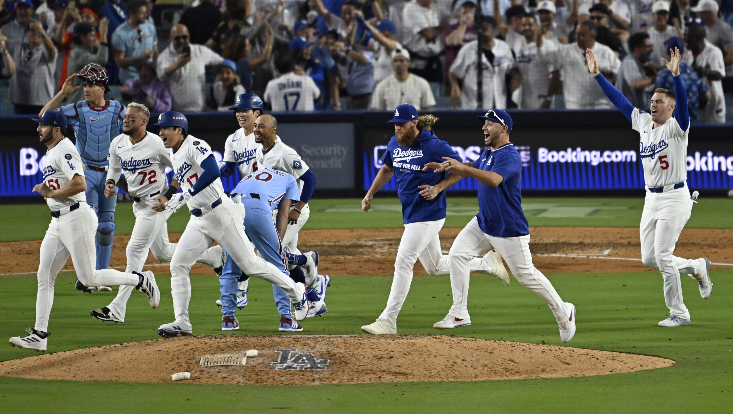 The Dodgers run past Philadelphia Phillies relief pitcher Orion Kerkering...