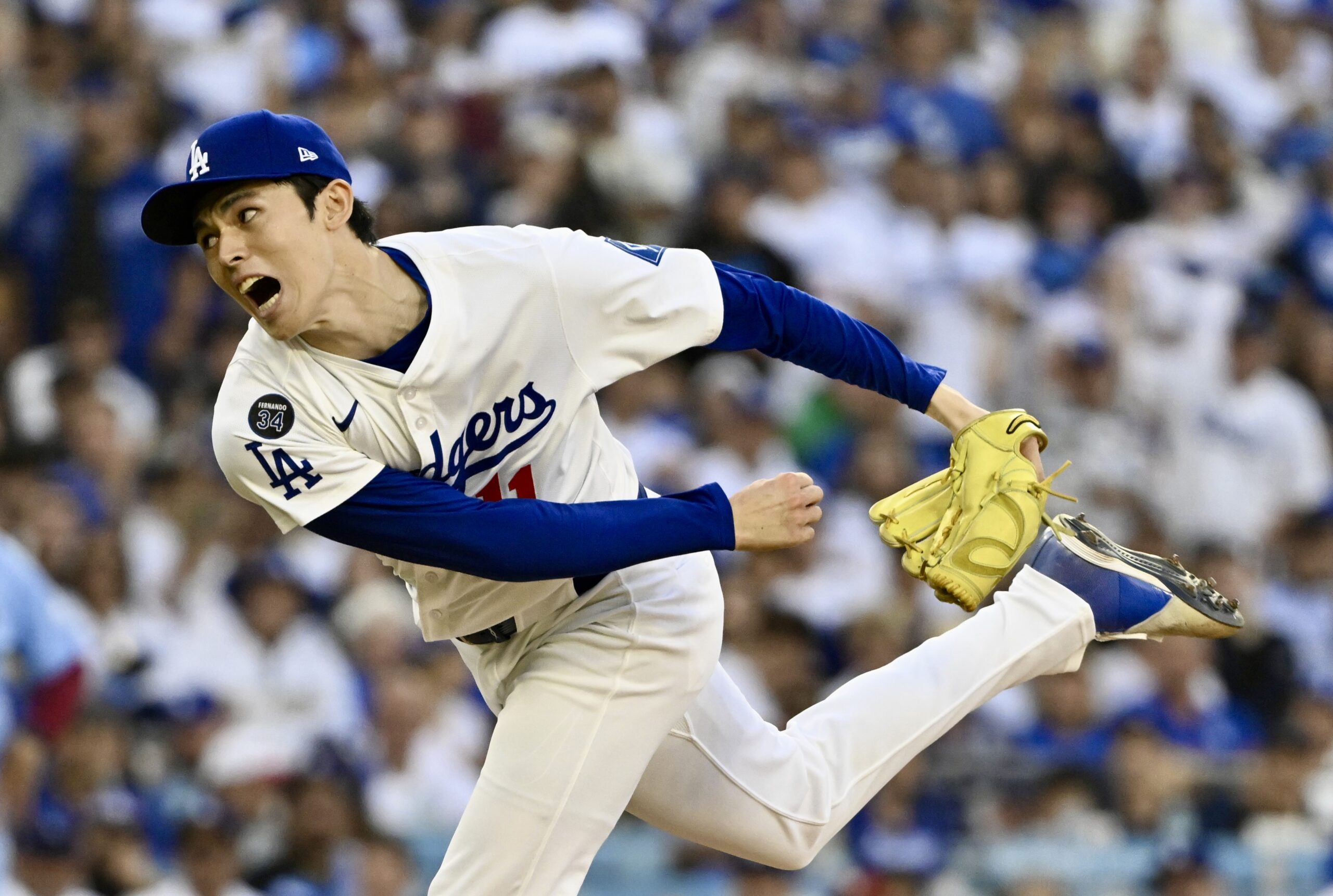 Dodgers relief pitcher Roki Sasaki throws to the plate during...