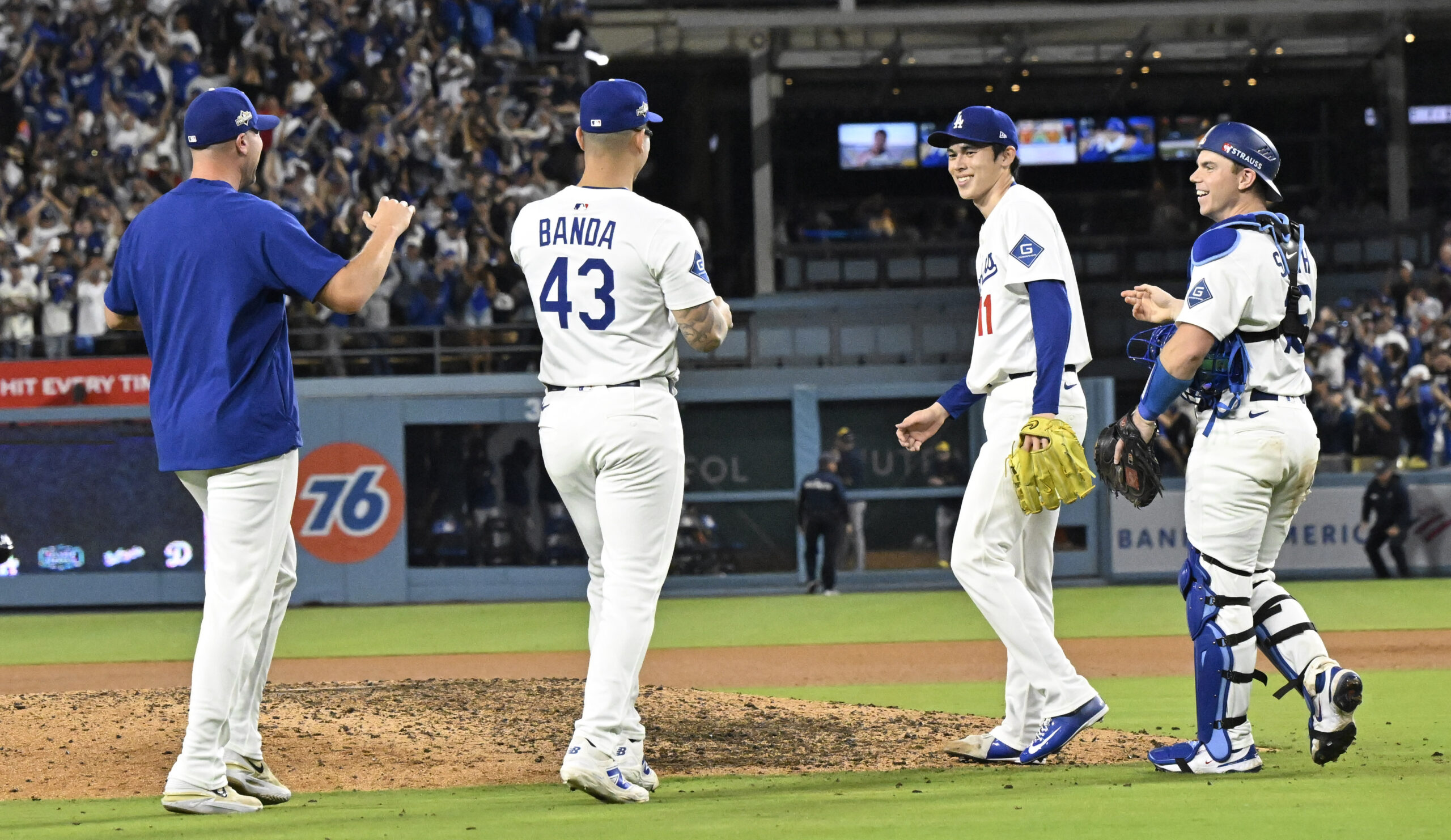 Cather Will Smith, right, along with relief pitcher Roki Sasaki...