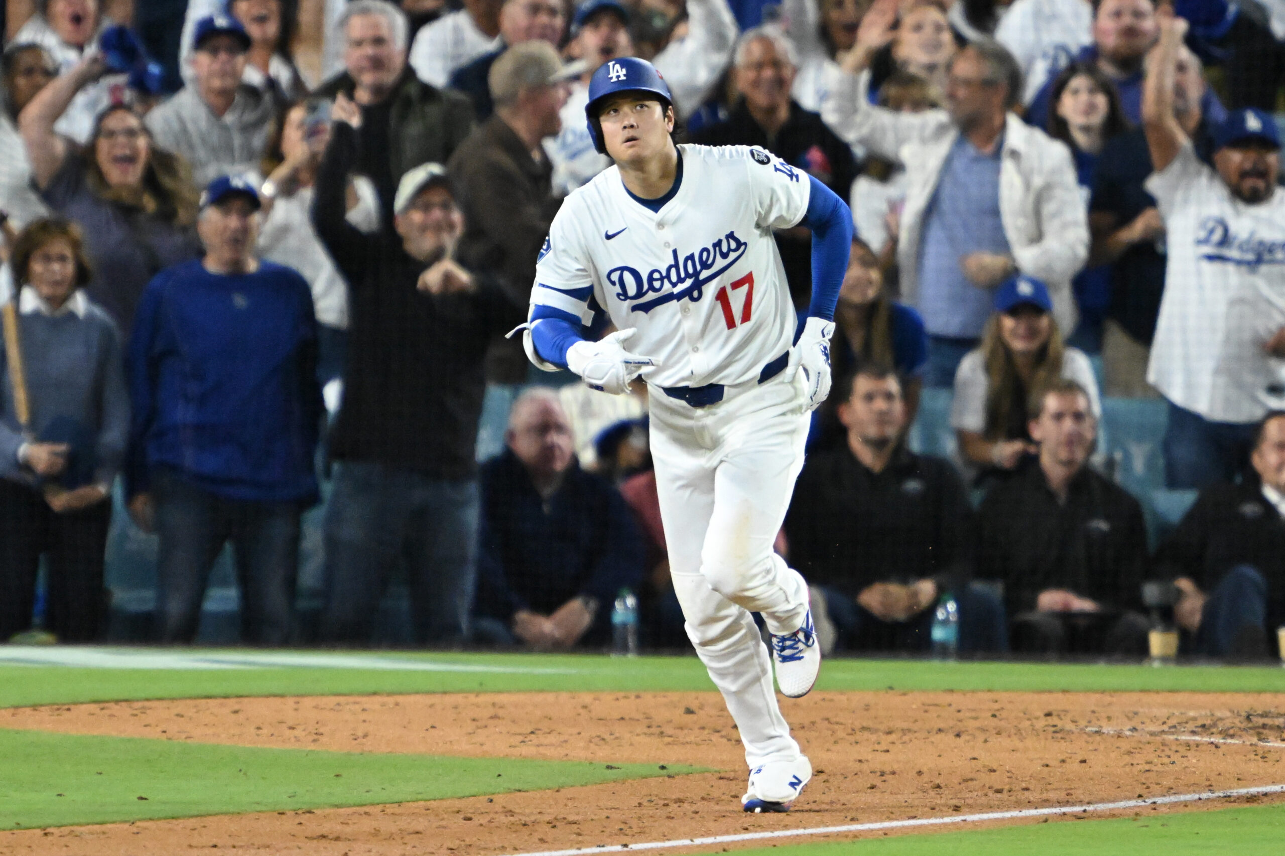 Dodgers star Shohei Ohtani begins to run the bases after...