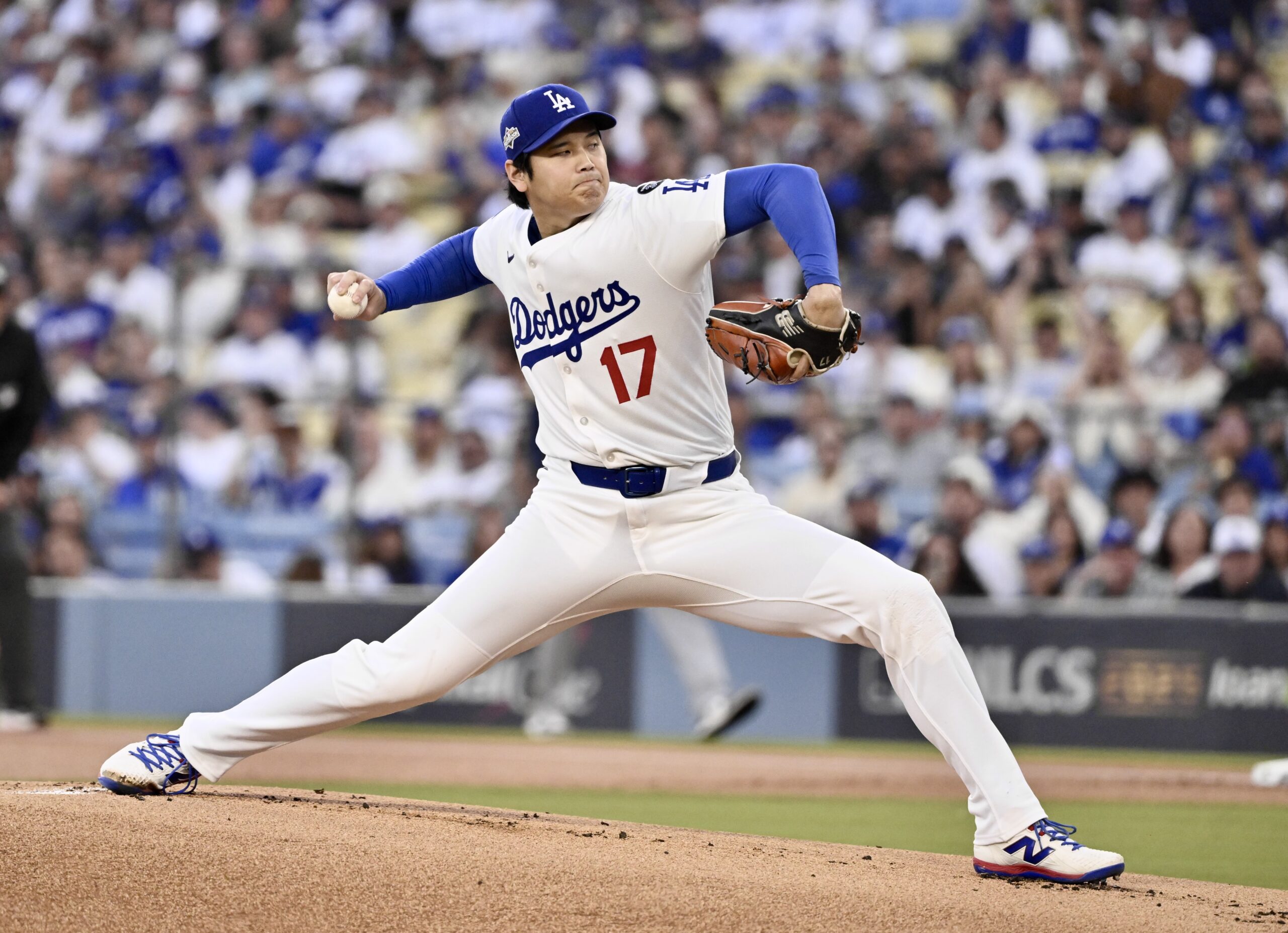 Dodgers starting pitcher Shohei Ohtani throws to the plate during...
