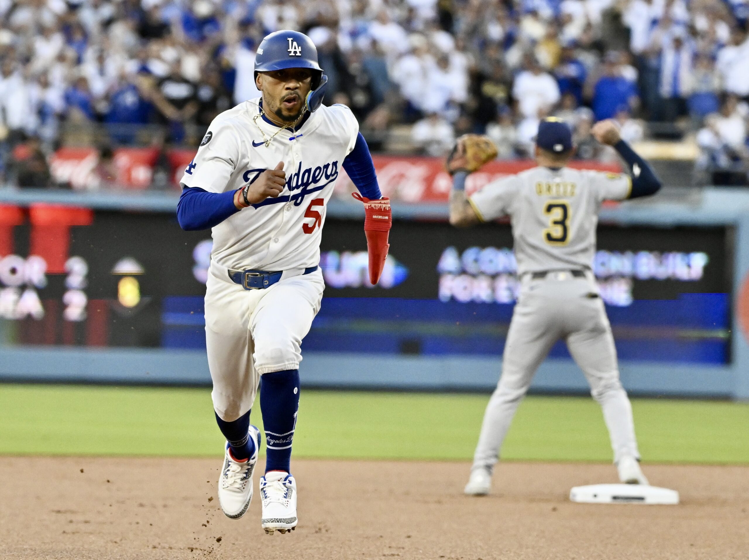 The Dodgers’ Mookie Betts advances to third base on a...