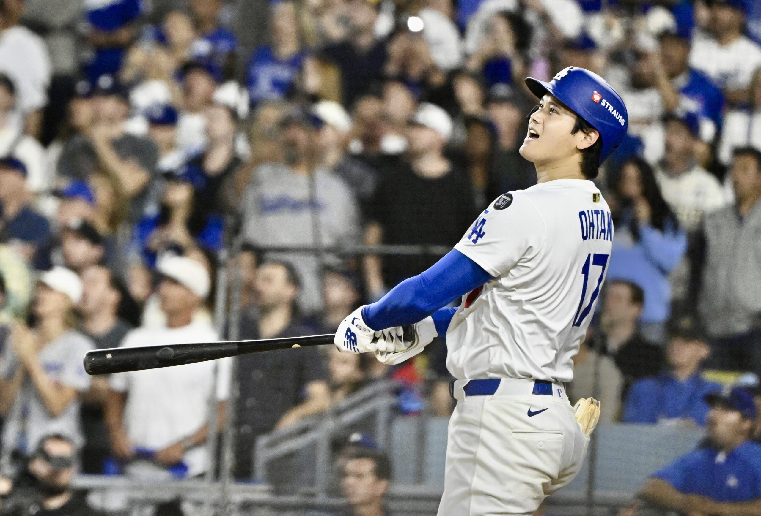 Dodgers star Shohei Ohtani watches the flight of his solo...