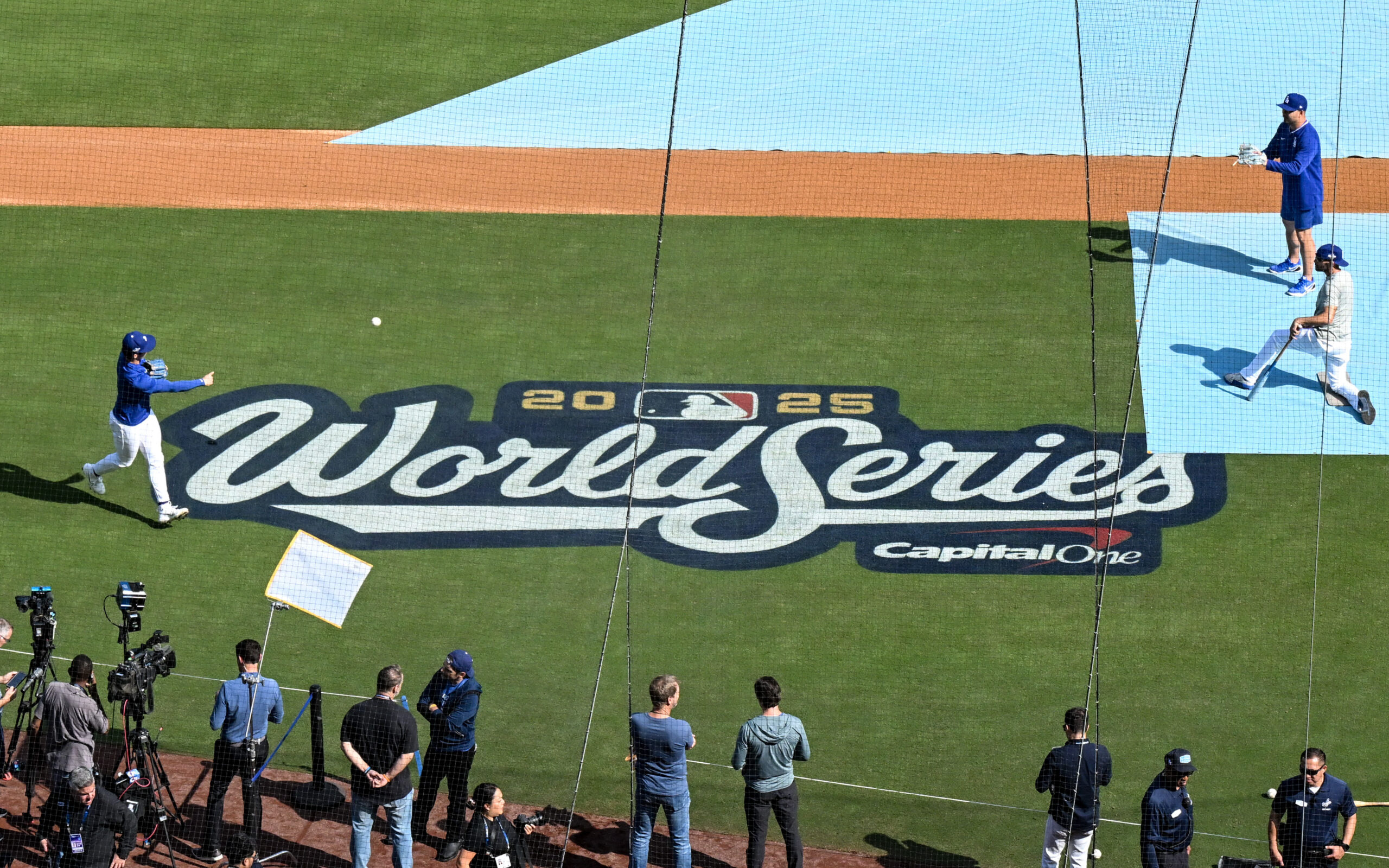Dodgers players warm up on the field before Game 3...