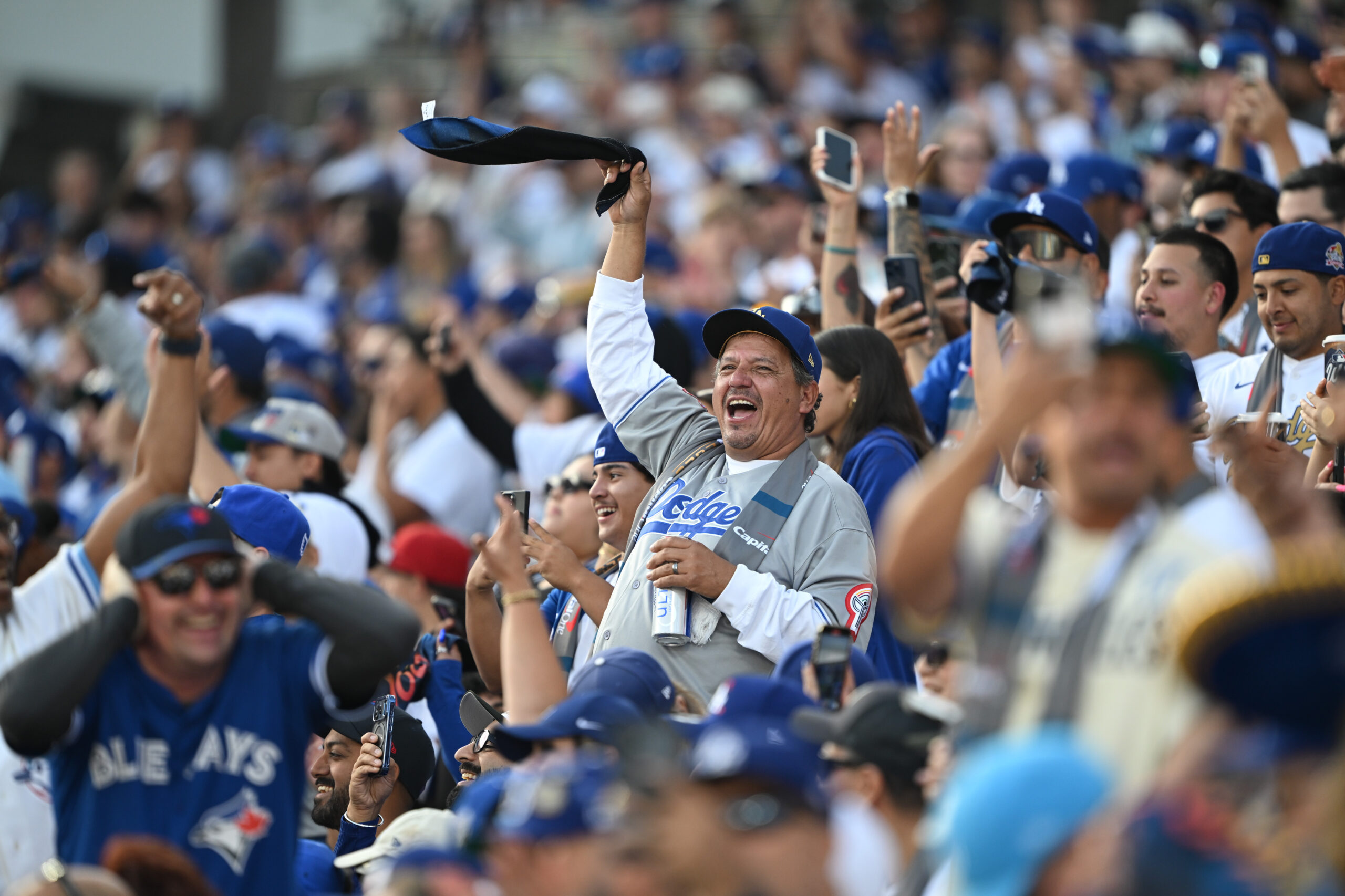 Dodger fans cheer in the stands during the first inning...