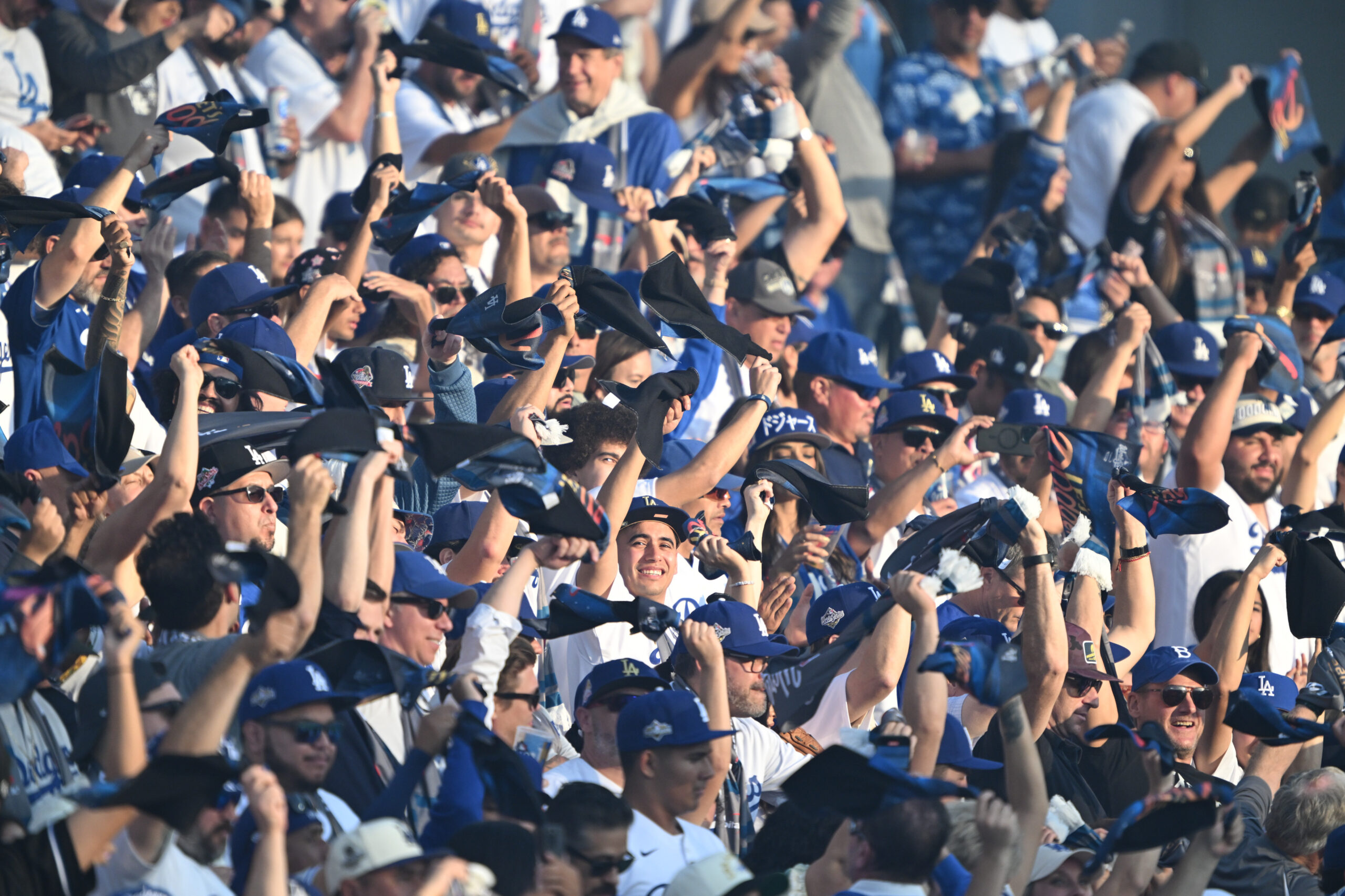Dodger fans cheer in the stands during the first inning...
