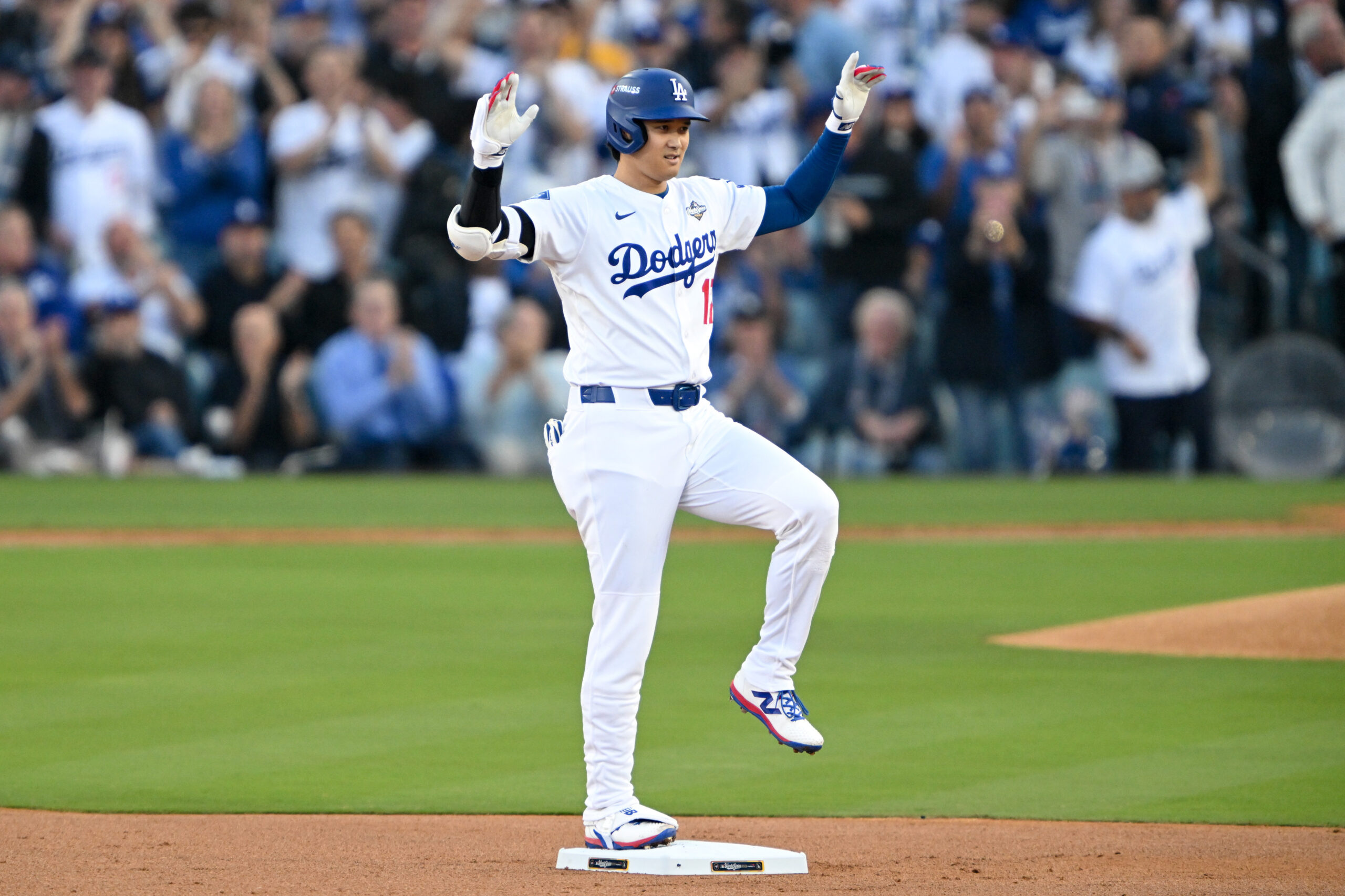 Dodgers star Shohei Ohtani gestures as he stands on second...