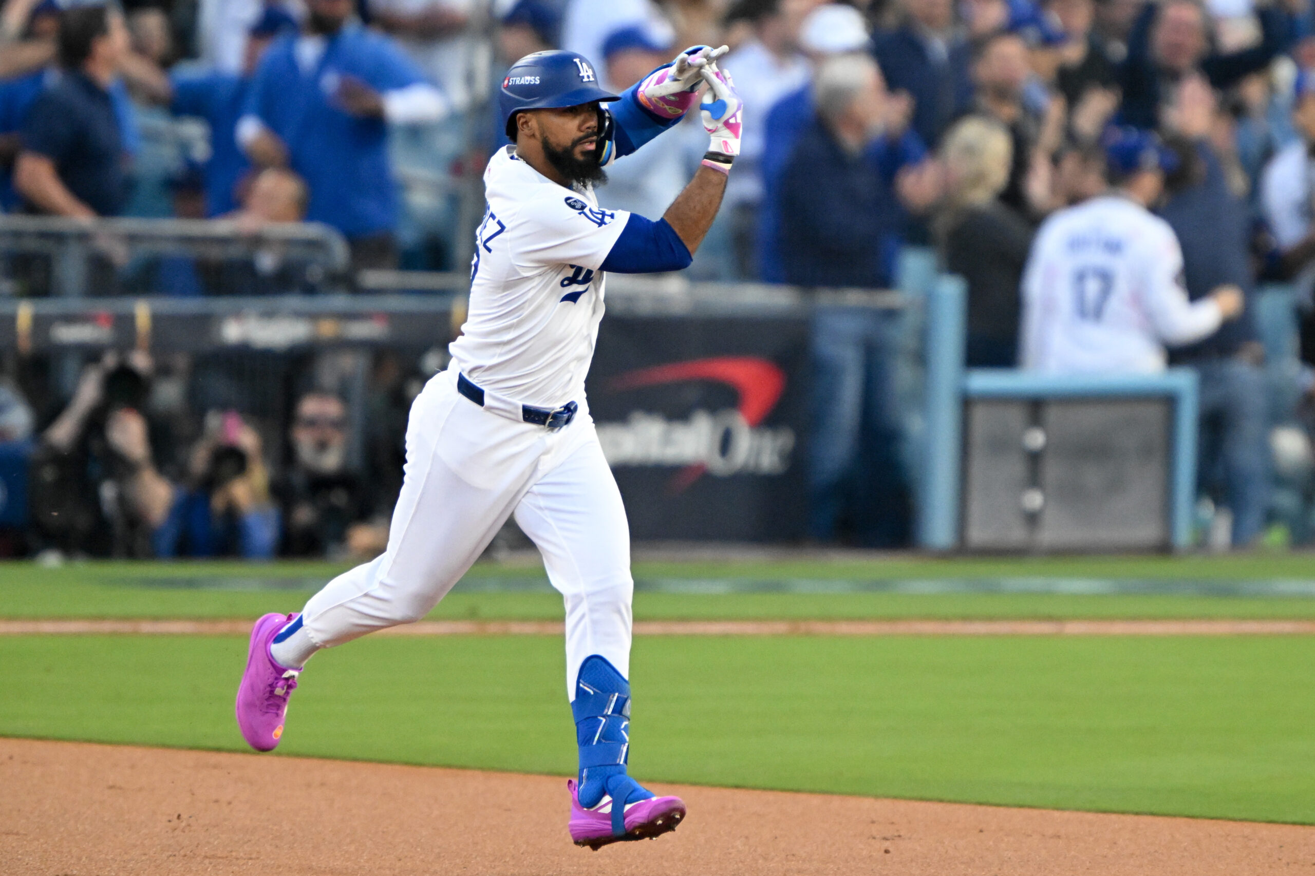 The Dodgers’ Teoscar Hernández gestures as he runs the bases...